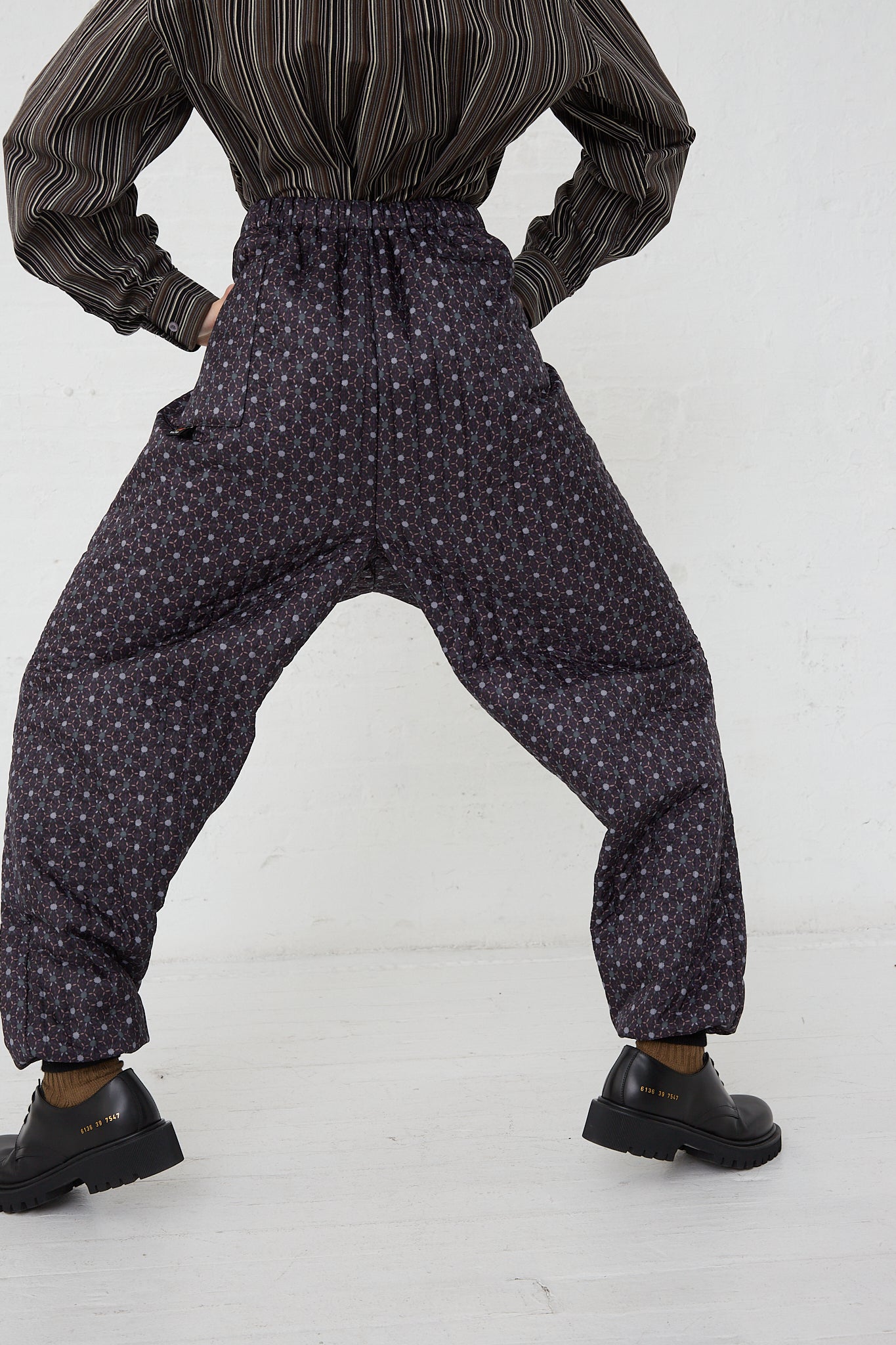 A woman wearing Bless Monpe Pant No. 08 in Floral Print A - L with an elasticated waist and a striped shirt.