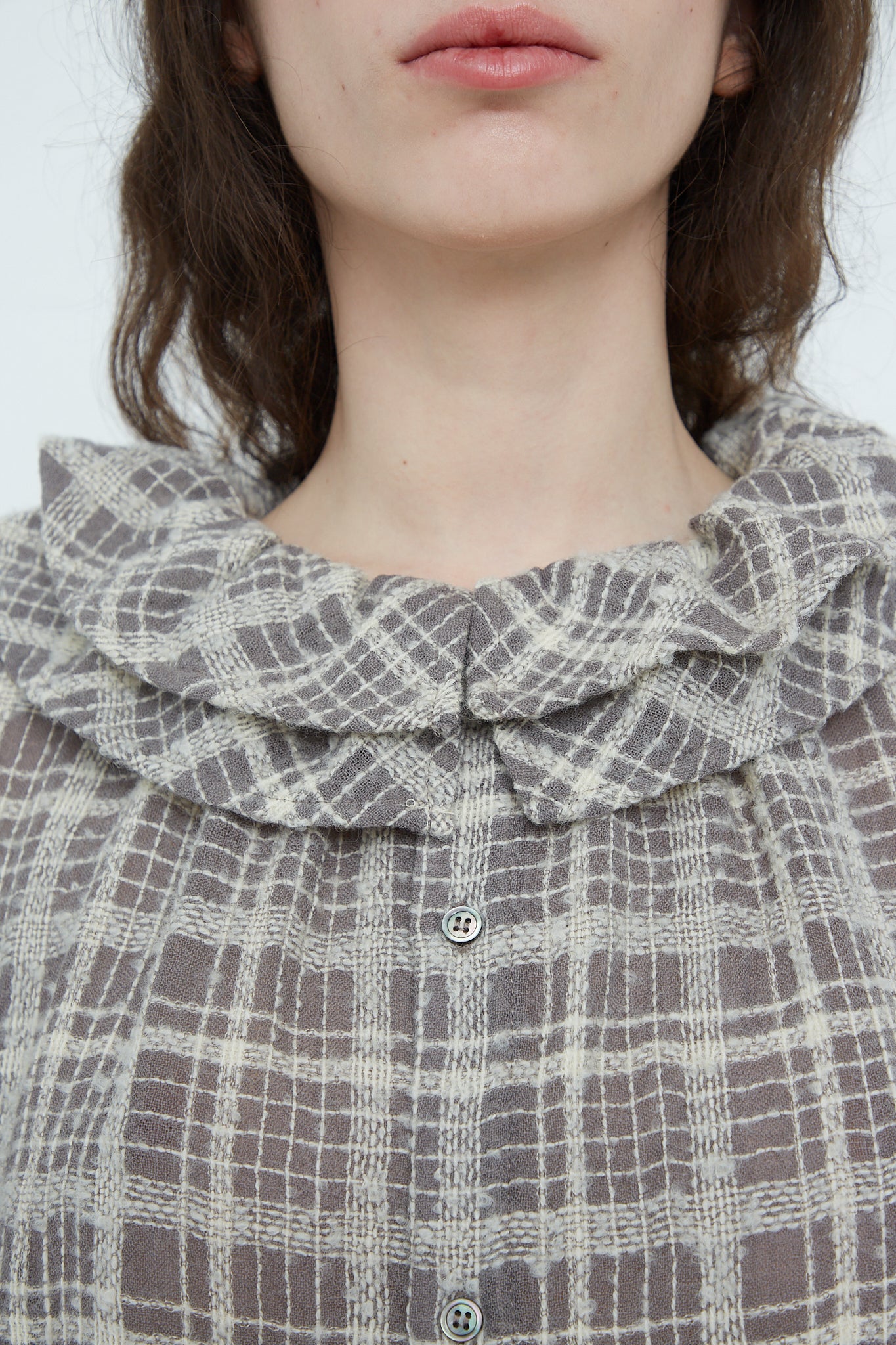 A woman wearing a Wool Check Frill Dress in Mocha by Ichi Antiquités. Up close view.