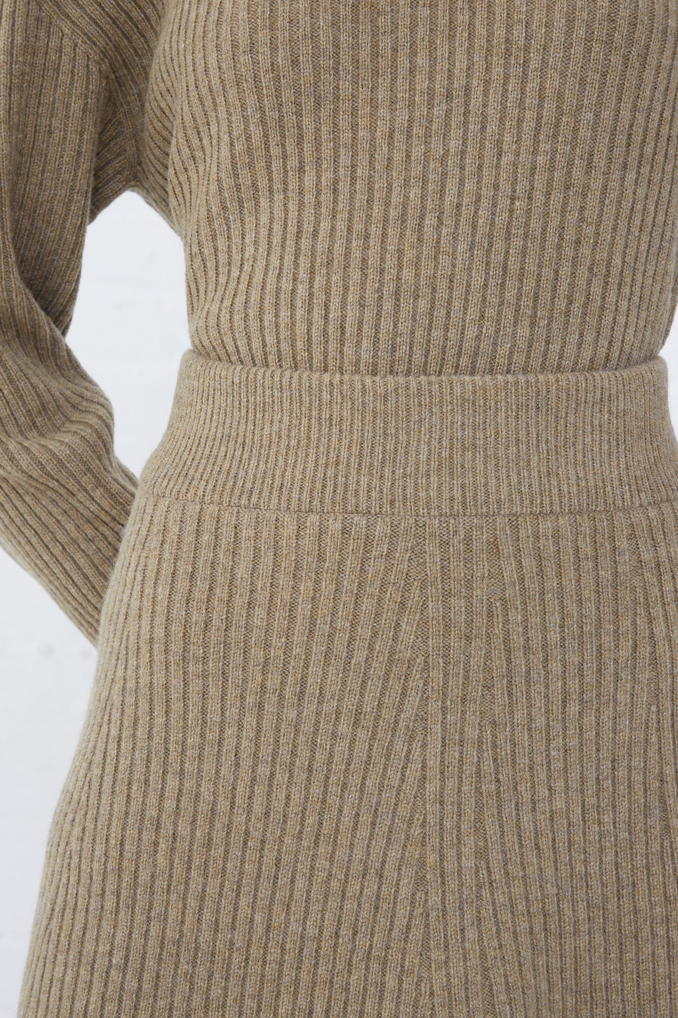 The back view of a woman wearing an Ichi Antiquités Wool Rib Knit Skirt in Mocha.
