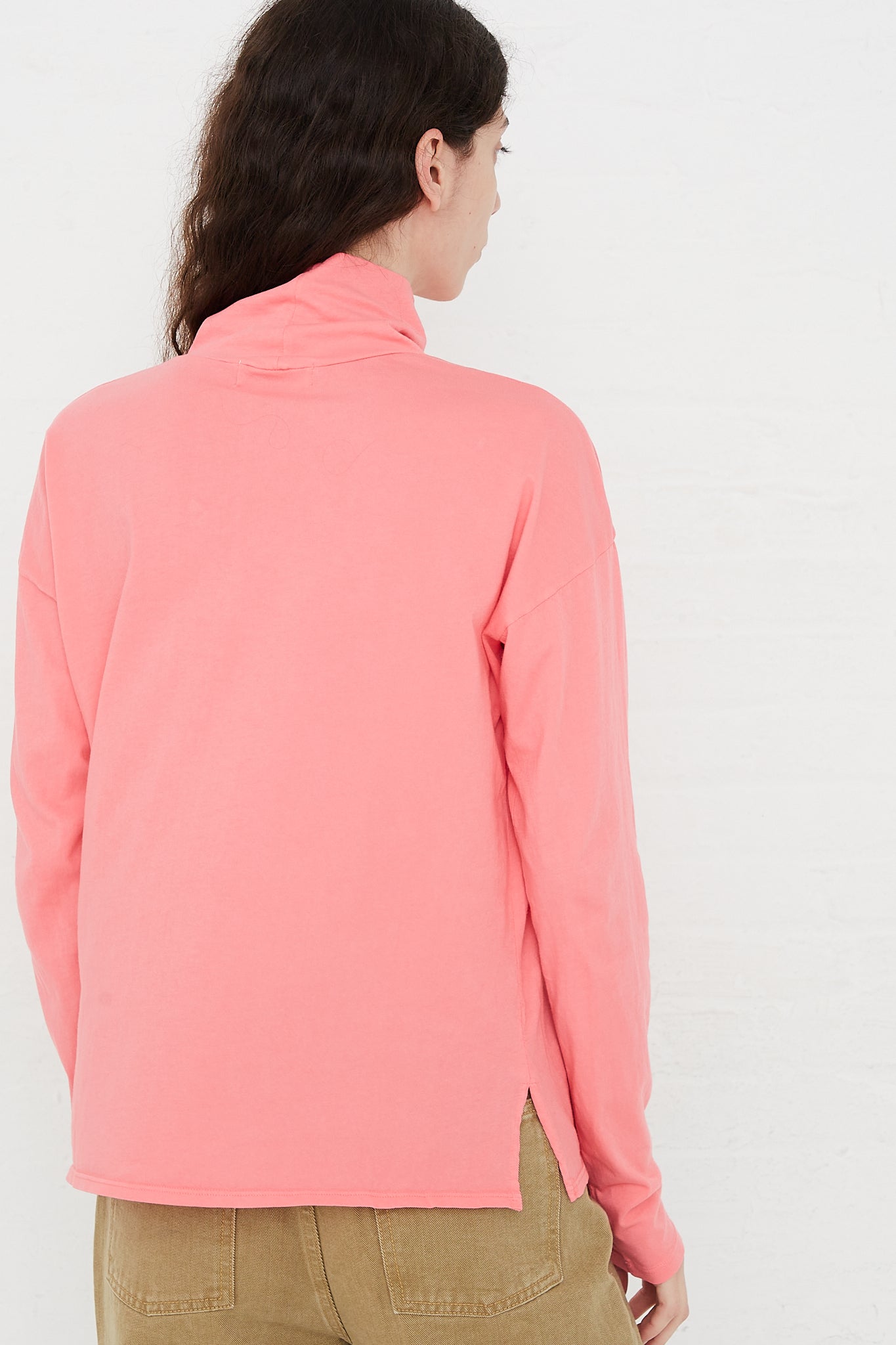 A model wearing a Calla Pink Cotton Turtleneck Shirt from the B Sides brand.