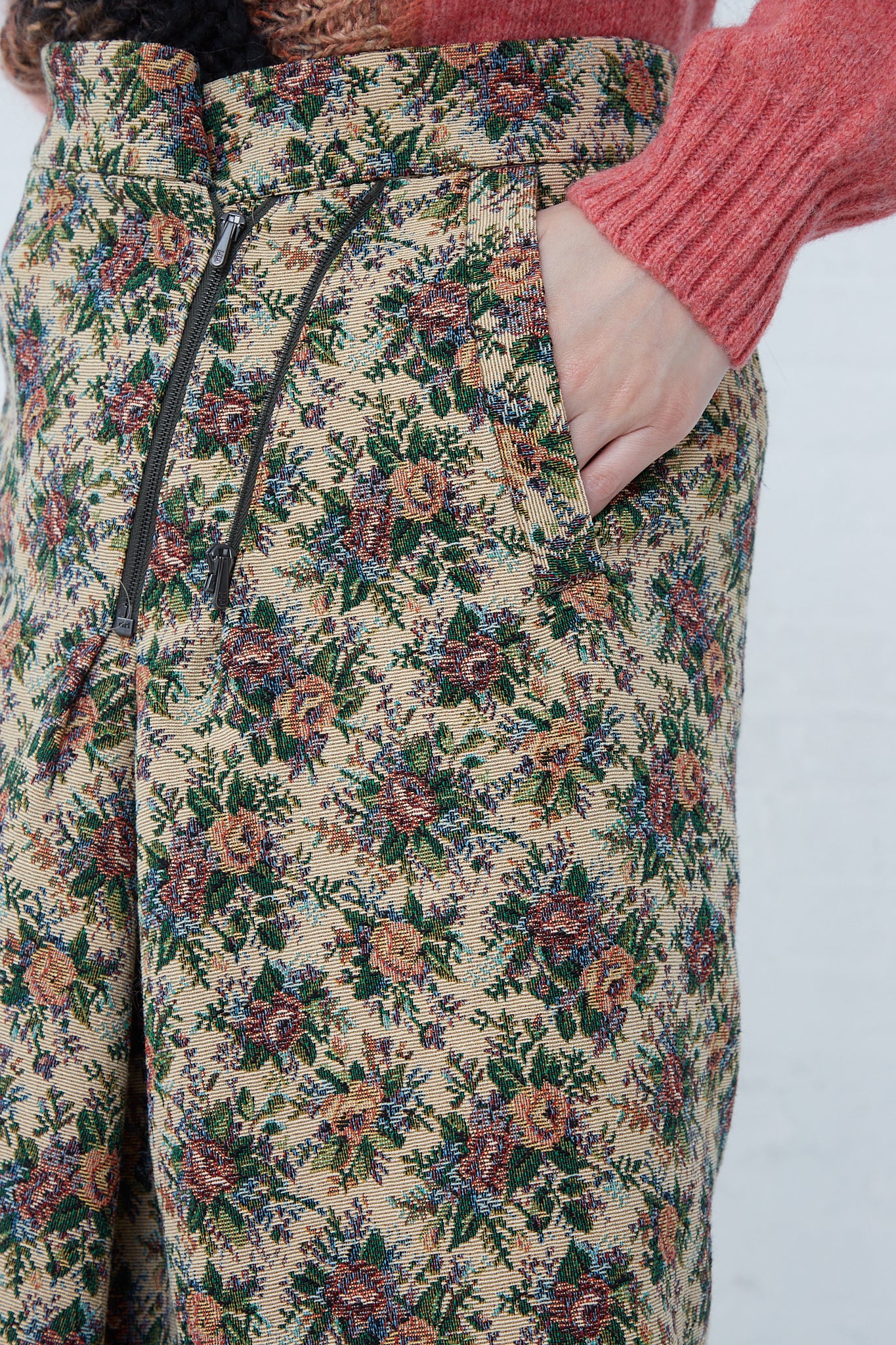 A woman is wearing a Bless SMLXL Skirt No. 75 in Flower made from a brocade cotton blend.