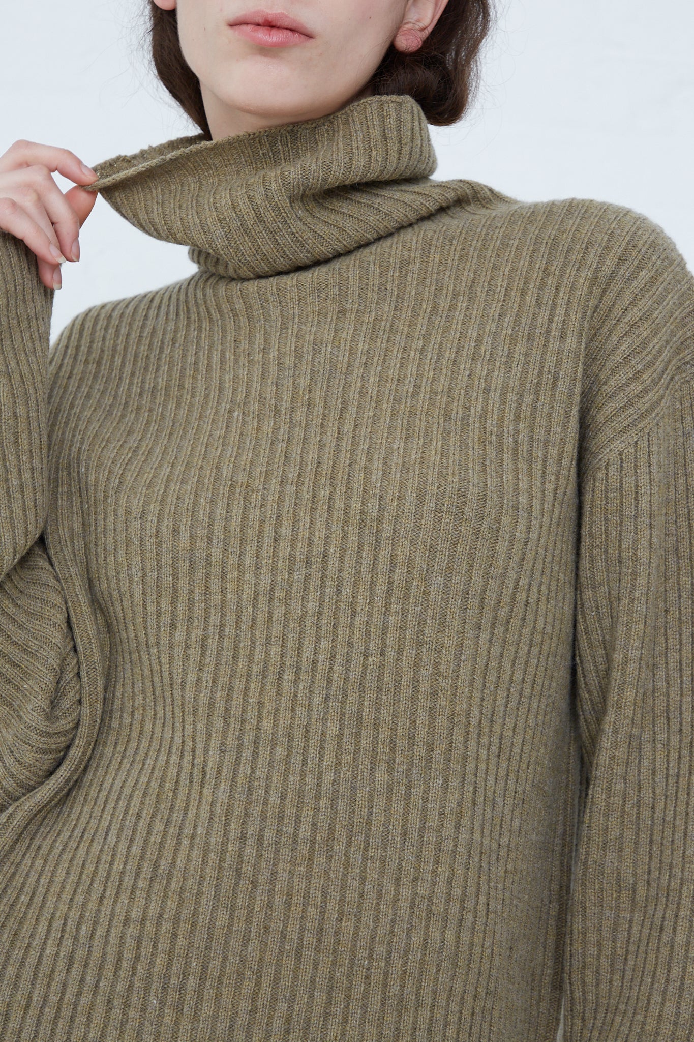 The model is wearing a relaxed fit, Ichi Antiquités Wool Rib Knit Turtleneck in Mocha sweater.