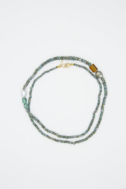 A Mary MacGill 14K Stone Layering Necklace in Green with turquoise beads and a gold clasp.