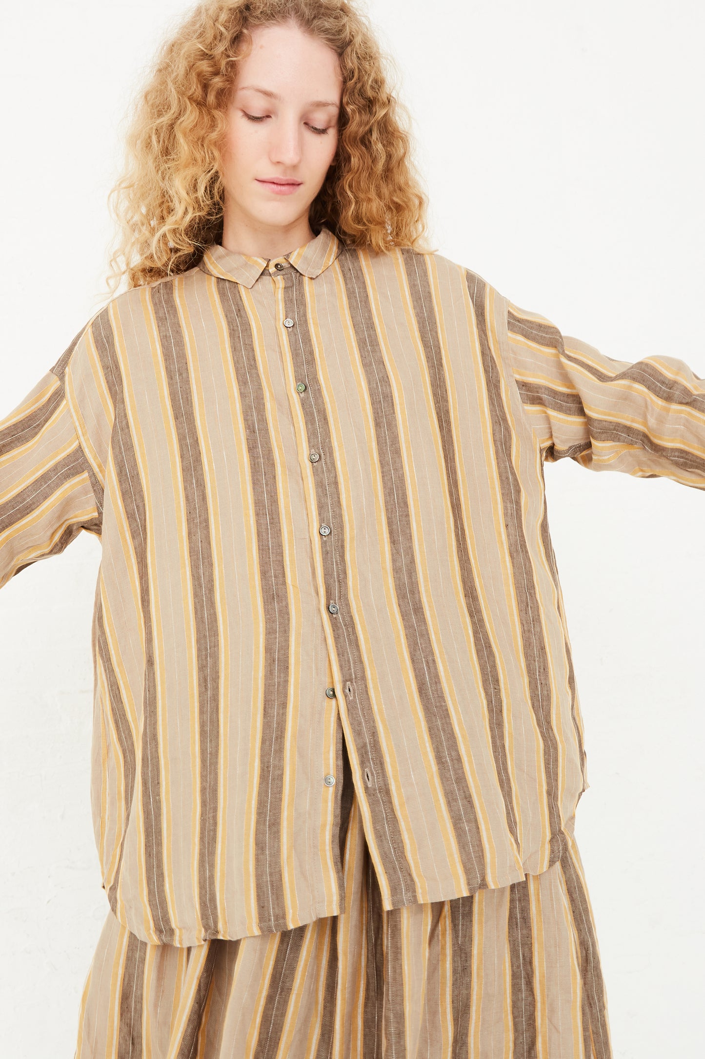 A model in a relaxed fit, Ichi Antiquités Linen Stripe Shirt in Mustard, available at Oroboro store in NYC.