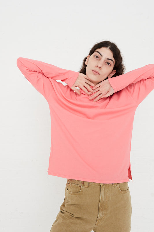 A model wearing a Cotton Turtleneck Shirt in Calla Pink and khaki pants for B Sides brand.