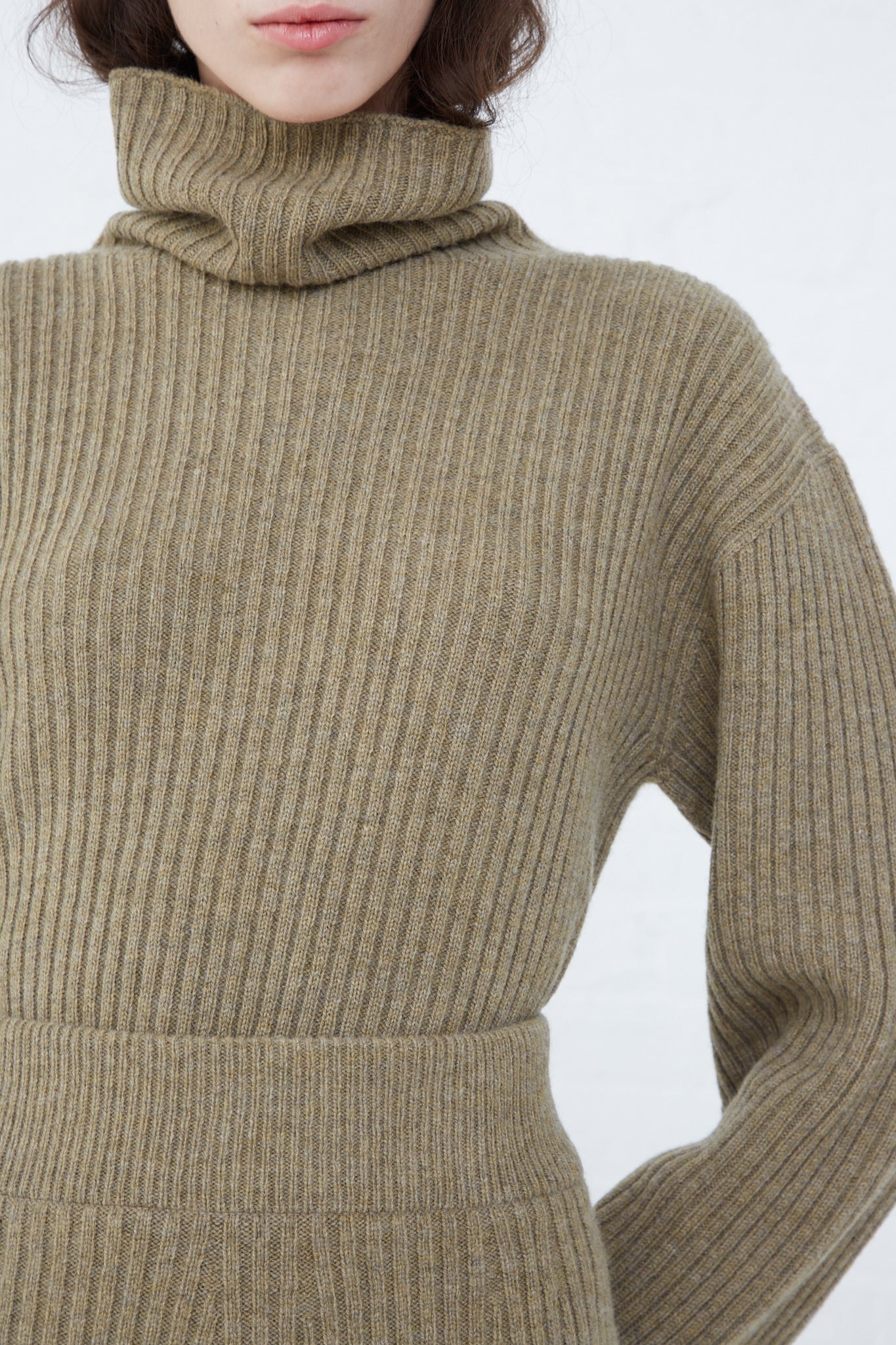 A model wearing a relaxed fit, Wool Rib Knit Turtleneck in Mocha from Ichi Antiquités.