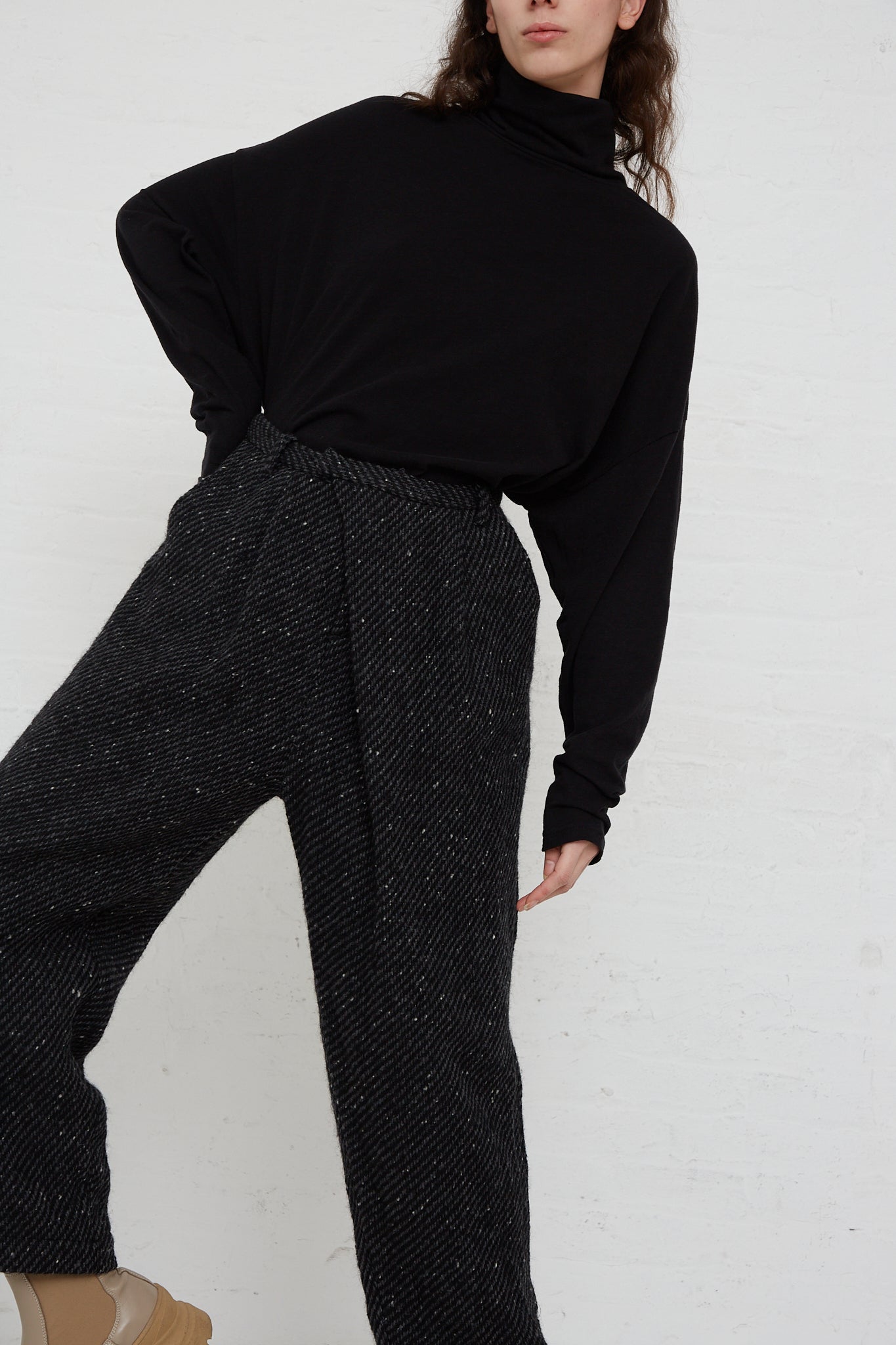 A woman wearing the Ichi Antiquités Snow Nep Wool Pant in Black and a black turtleneck sweater.