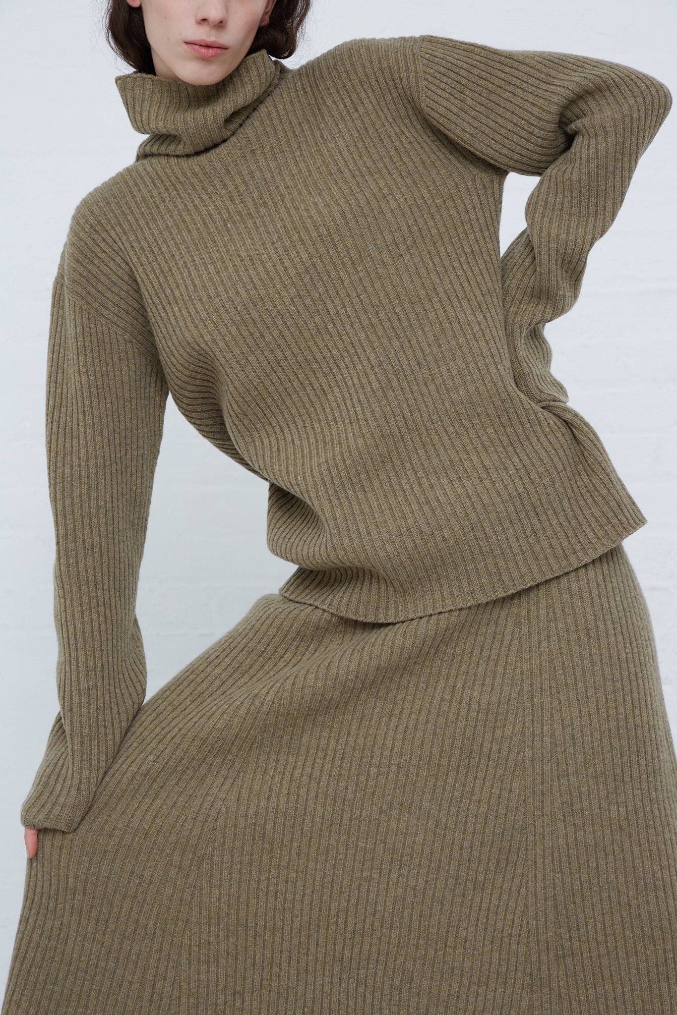 A model showcasing an Ichi Antiquités Wool Rib Knit Turtleneck in Mocha paired with a midi skirt.