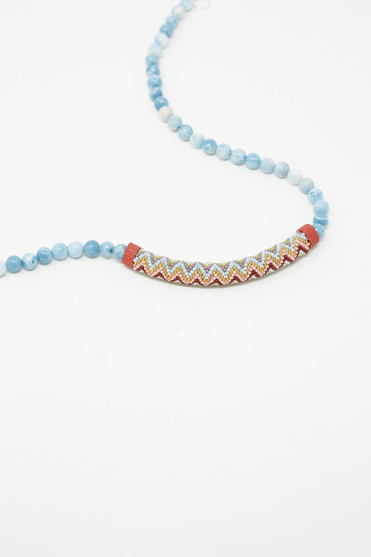 A blue and red Beaded Bar Necklace in Larimar featuring Robin Mollicone beads with a chevron pattern.
