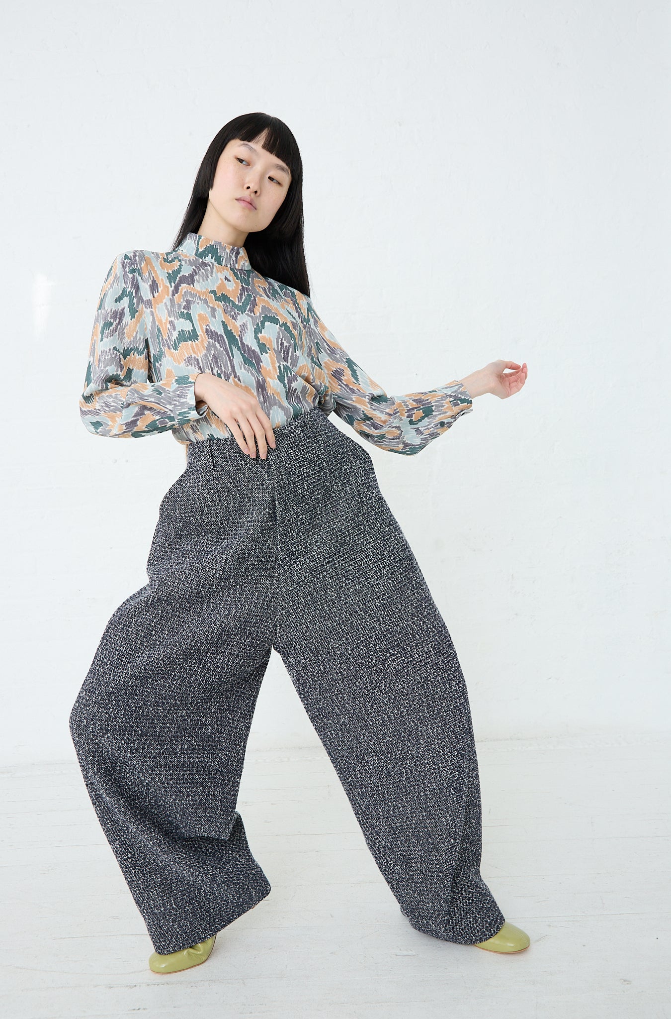 A woman wearing Mina Perhonen's Predawn Trouser in Navy Mix wide leg pants made in Japan and a blouse in a relaxed fit. Front view. 