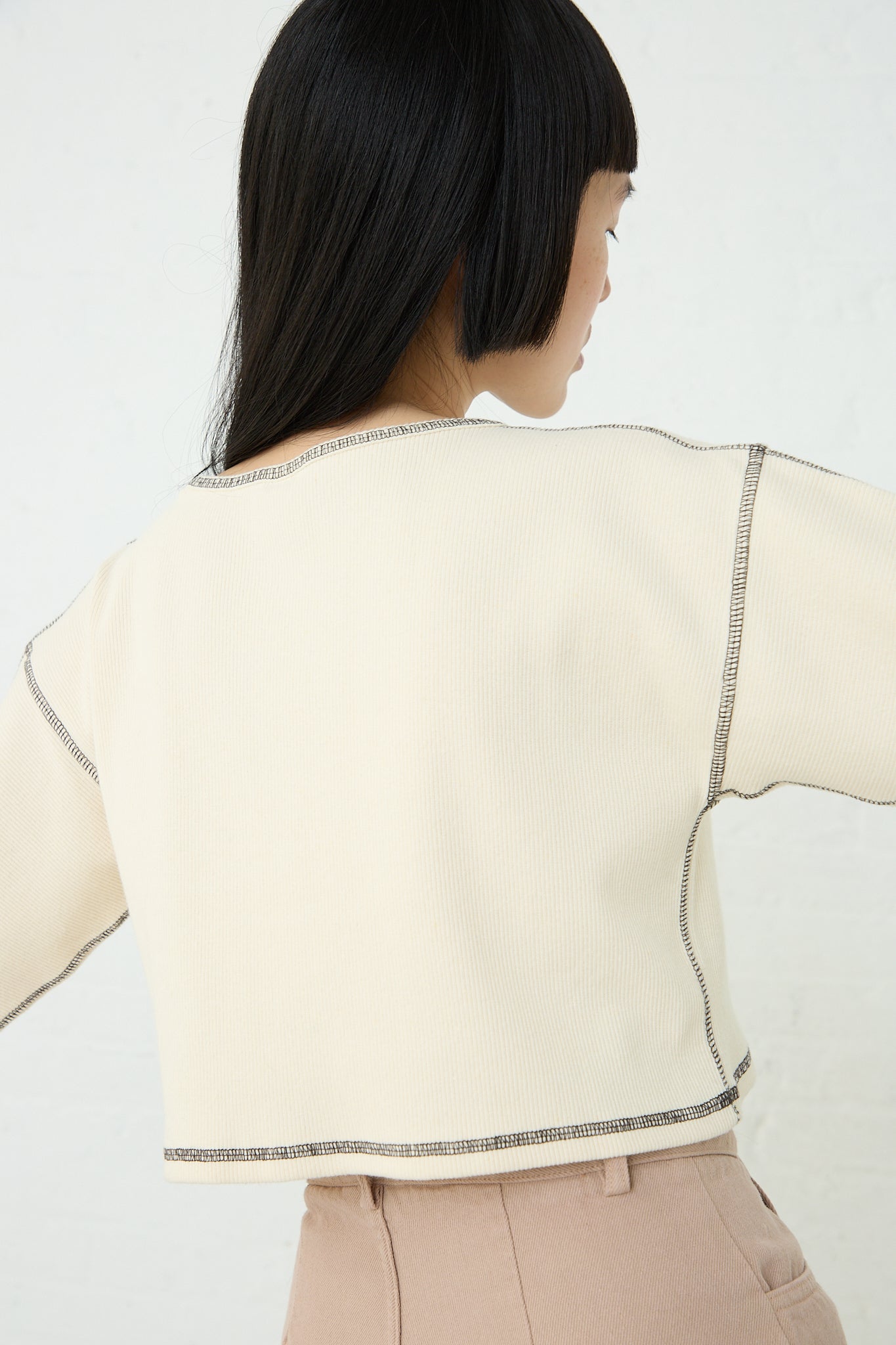 The back view of a woman wearing a Baserange Cotton Hemp Rib Garble Top in Undyed made from organic cotton blend.