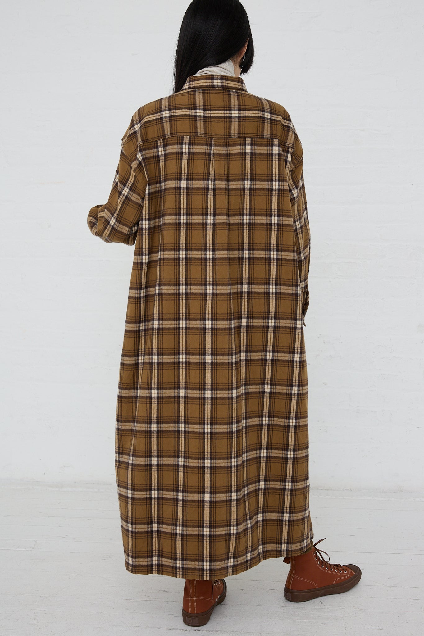 The back view of a woman wearing an Ichi Woven Cotton Dress in Camel made with woven plaid cotton.