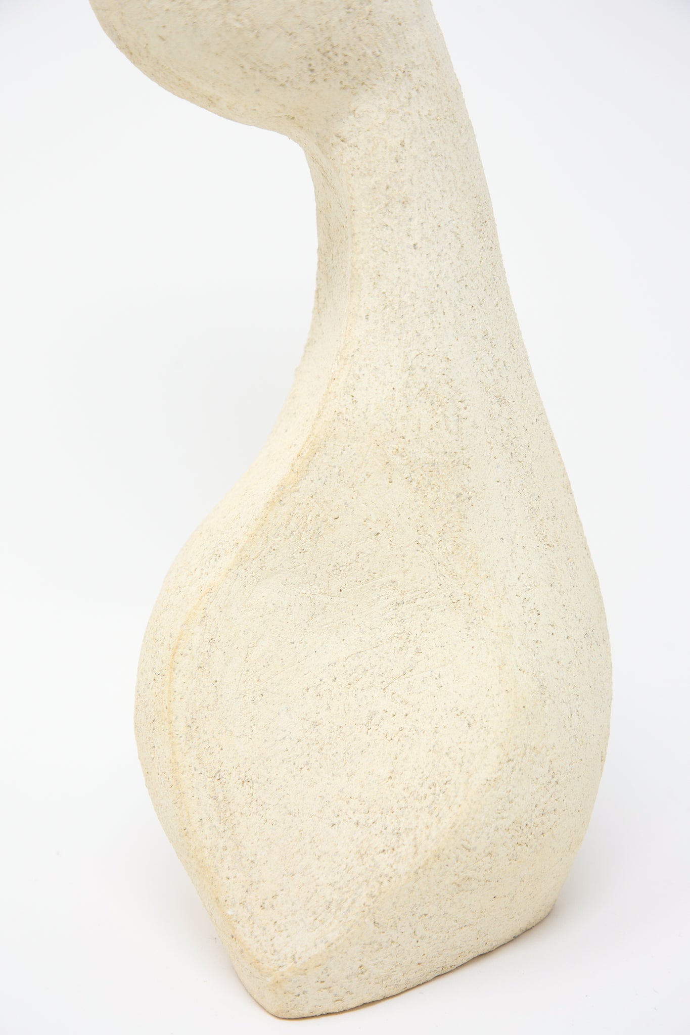 A Lost Quarry white sculpture on a white background, showcasing delicate floral arrangements, featuring the Medium Hand Built Vessel No. 000713 Bud Vase.