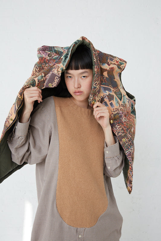 A woman wearing a Bless hooded coat with a floral pattern made of printed cotton blend.
