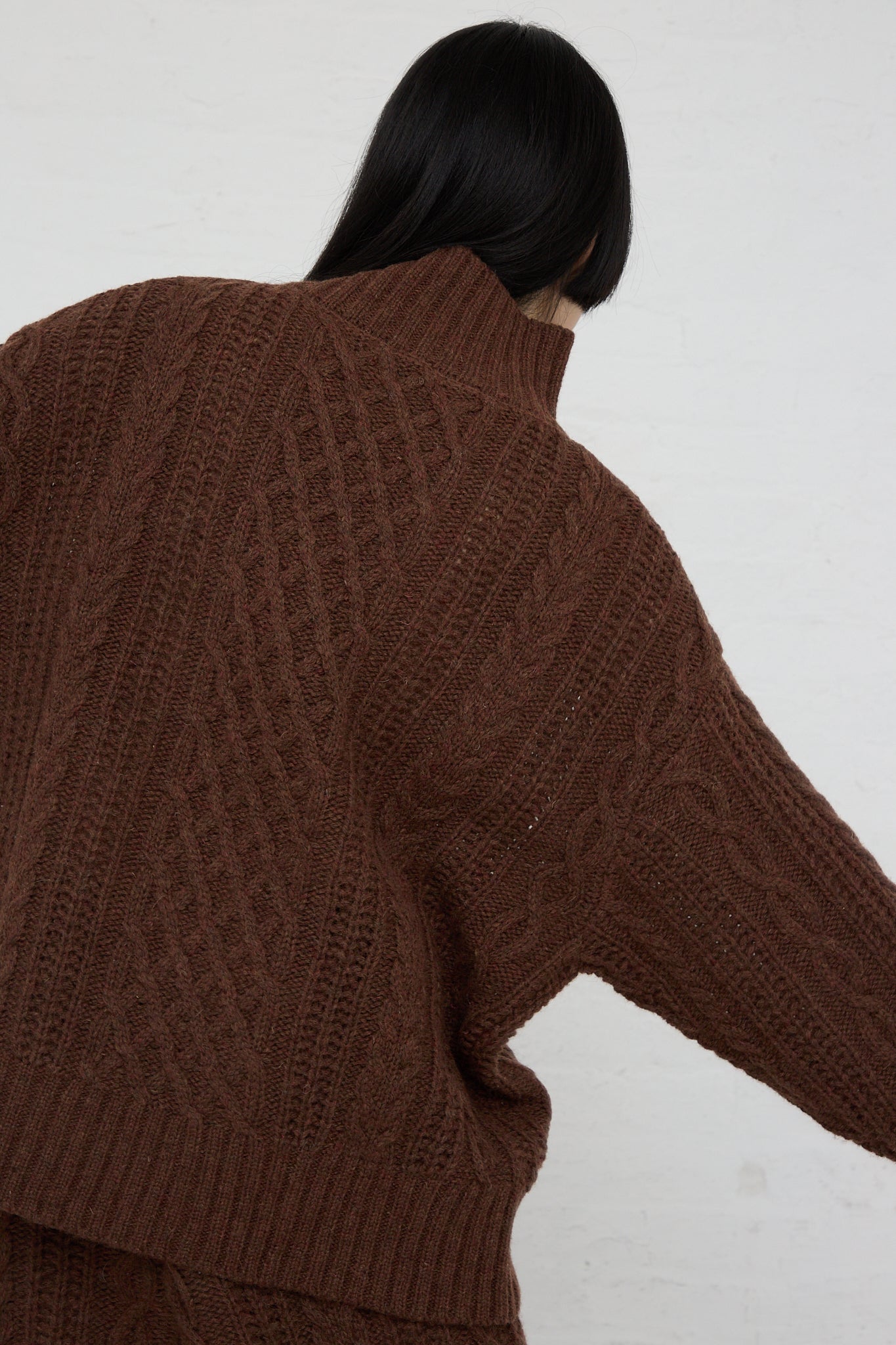 The back of a woman wearing an Ichi Knit Turtleneck Pullover in Brown.