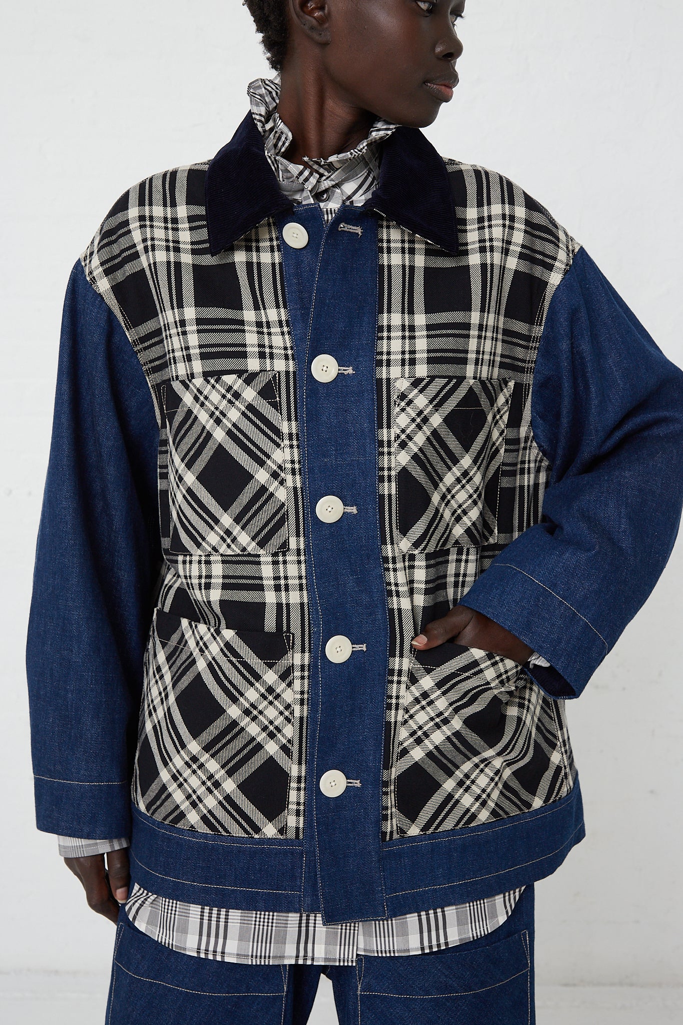 A woman in a KasMaria Japanese Denim Chore Jacket in Plaid, made of Japanese cotton, featuring a blue and black plaid pattern. Available at Oroboro Store in NYC.
