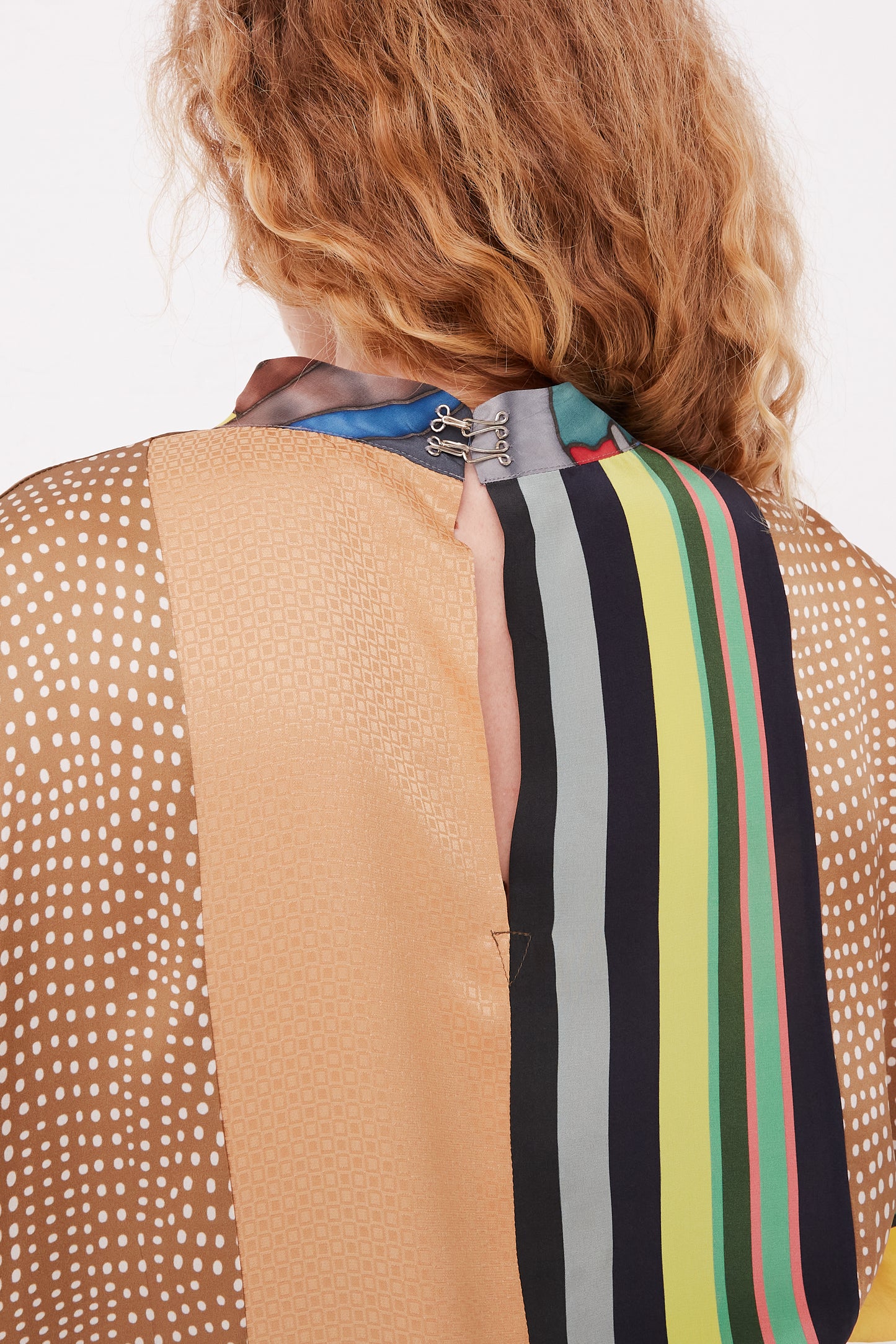 The back view of a woman wearing the Bettina Bakdal Silk Vintage Scarves Grit Dress with Classic Mandarin Collar - L.
