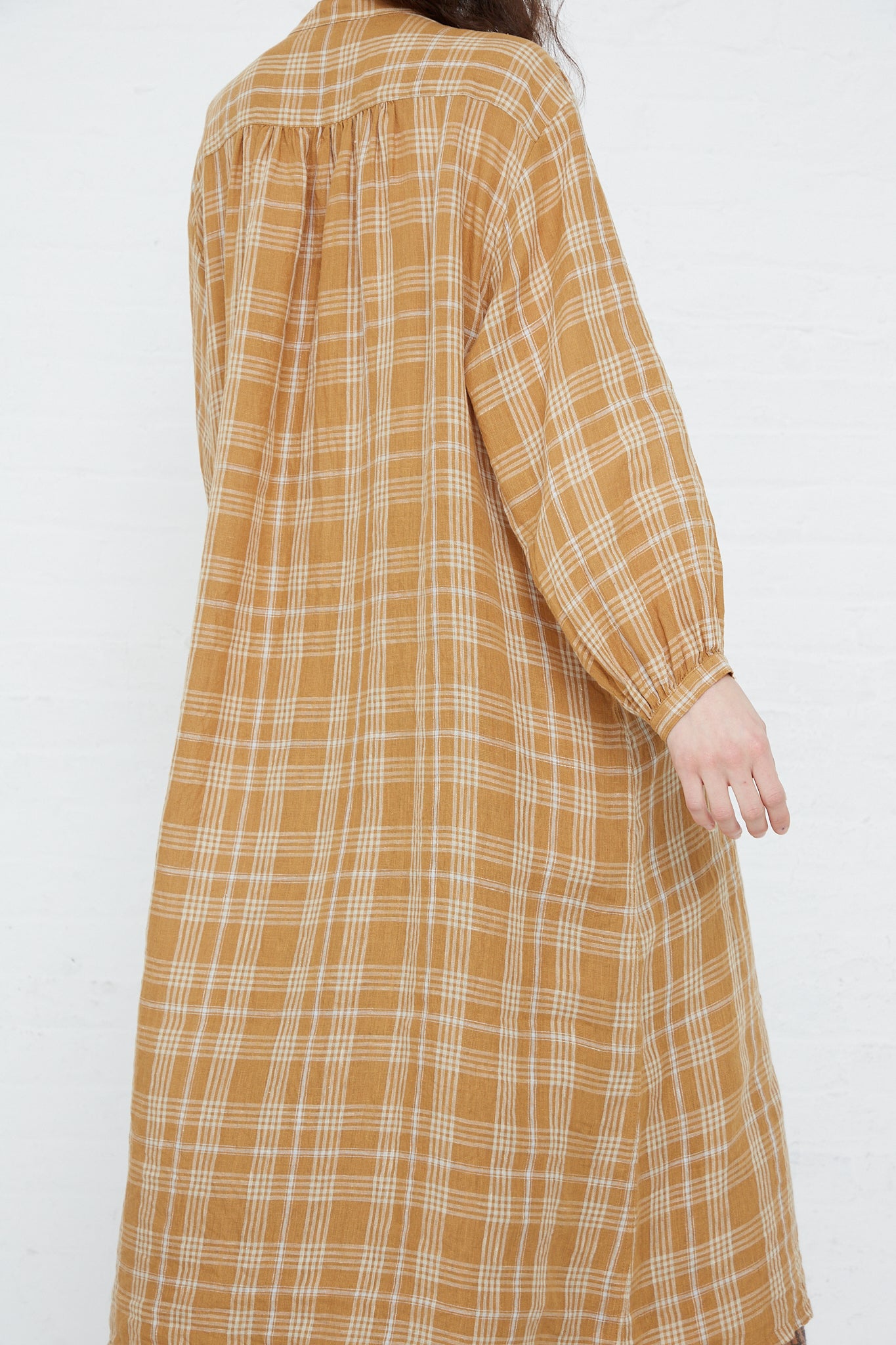 The back of a woman wearing a Linen Check Dress in Camel by Ichi Antiquités.