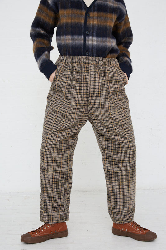A model wearing Ichi's Woven Pant in Mocha Check and a cozy sweater.