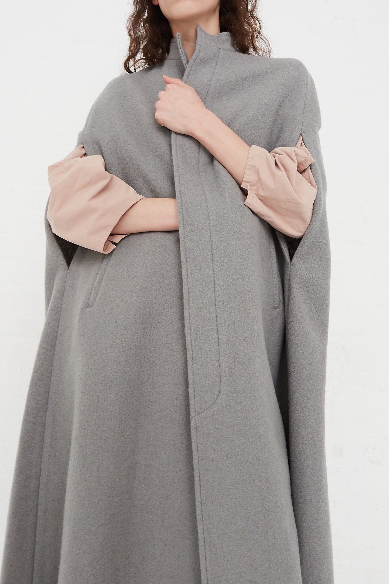 The model is wearing a Japanese Suffolk Melton Cloak in Grey made by Cosmic Wonder.
