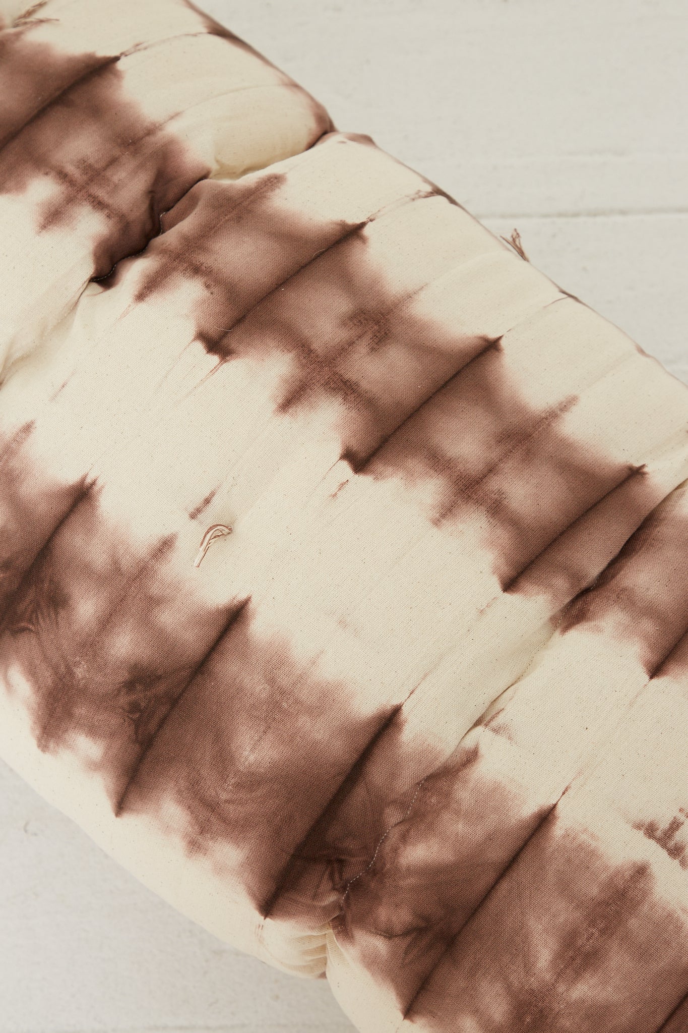 A Tufted Overlay Mattress in Chocolate Tie Dye by Tensira.