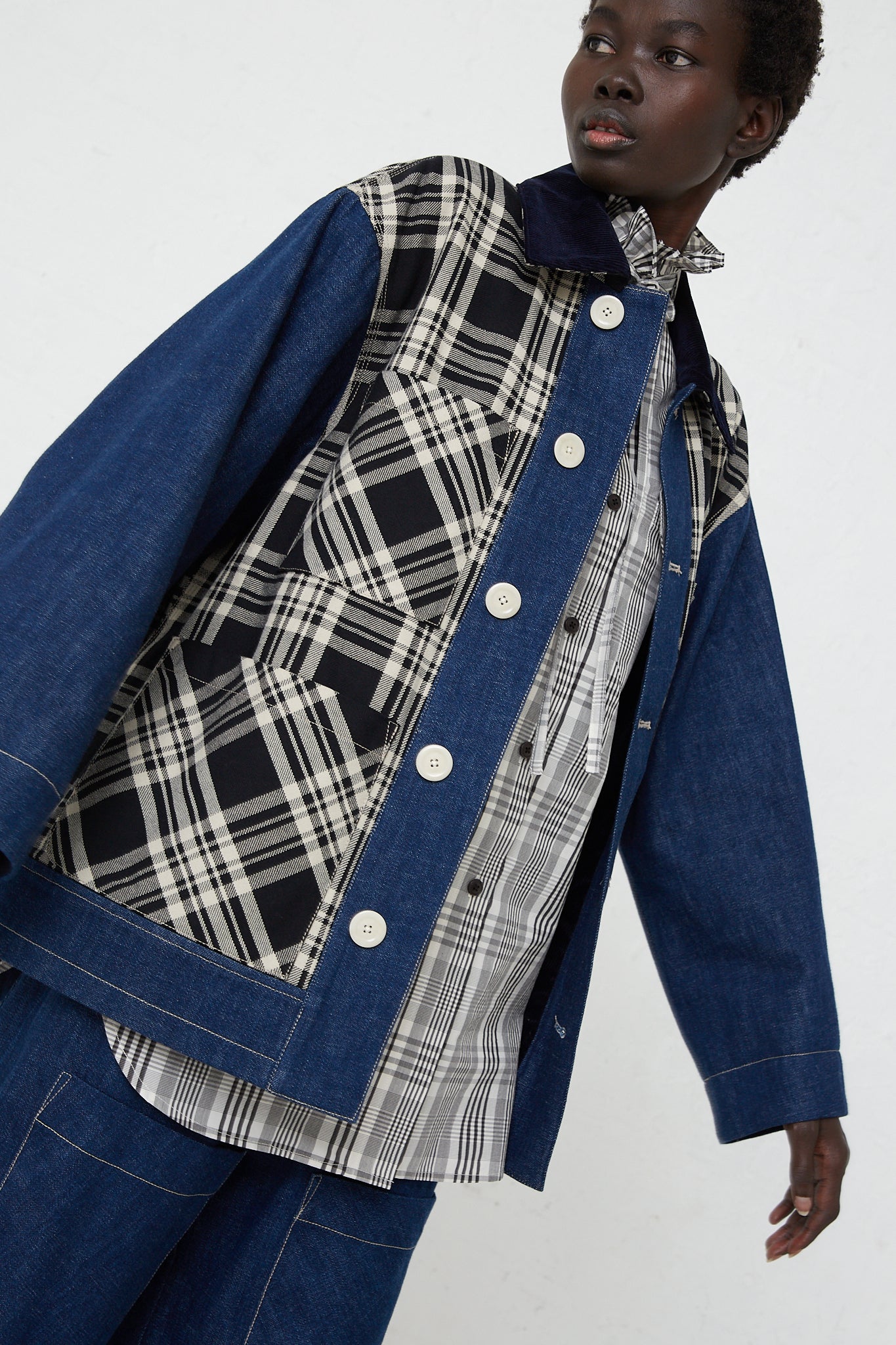 An oversized KasMaria Japanese Denim Chore Jacket in Plaid, made with Japanese cotton, worn by a woman.