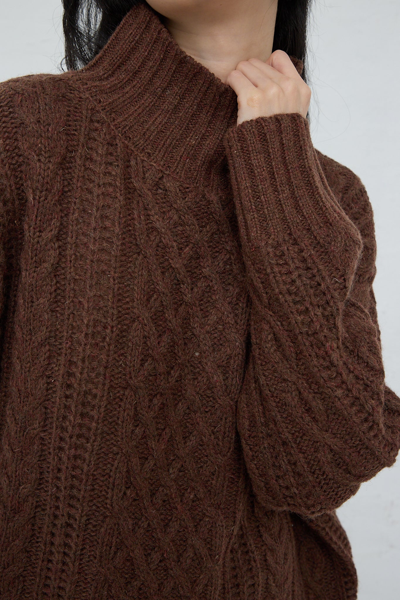 An Ichi Knit Turtleneck Pullover in Brown, a relaxed fit turtleneck pullover in a patterned wool blend. Up close.