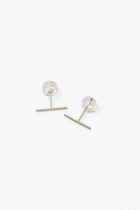 A pair of Kathleen Whitaker Staple Stud 1/2" Single Earrings in 14K Yellow Gold on a white surface.