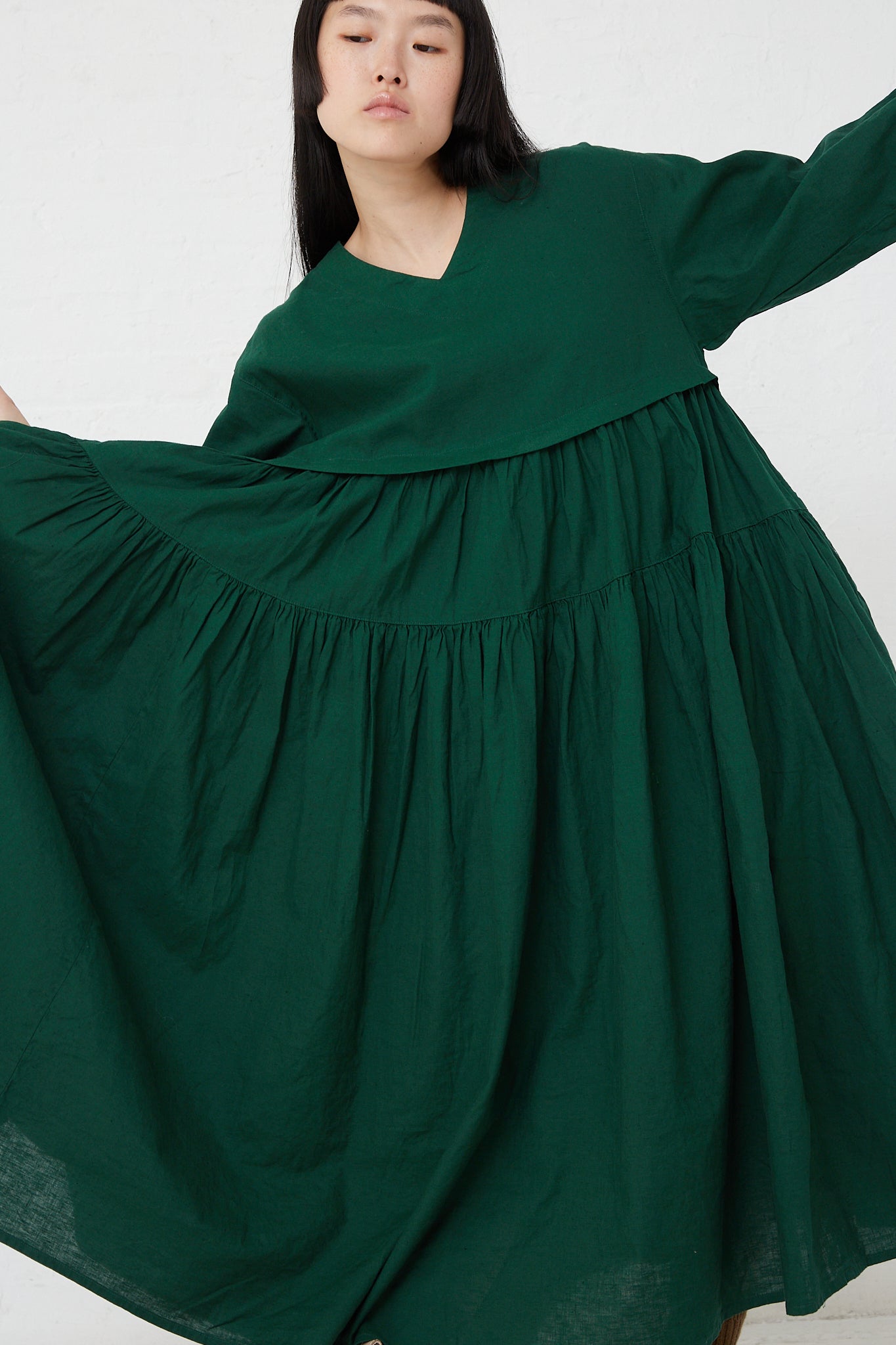 The model is wearing a UpcycleLino Linen Tiered Gather Dress in Green by nest Robe.