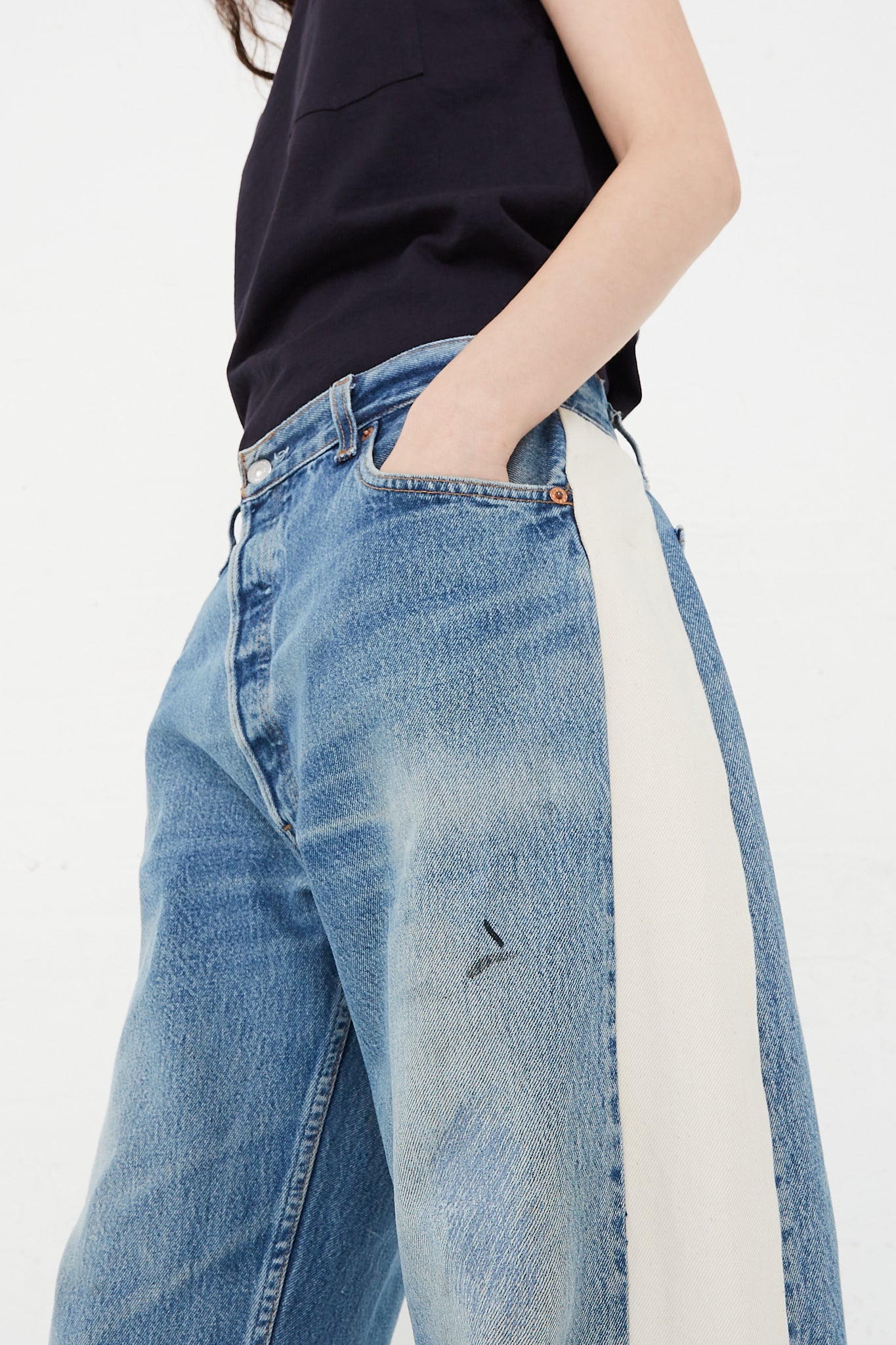 A model wearing a Reworked Slouch jean in Vintage Indigo top from B Sides.