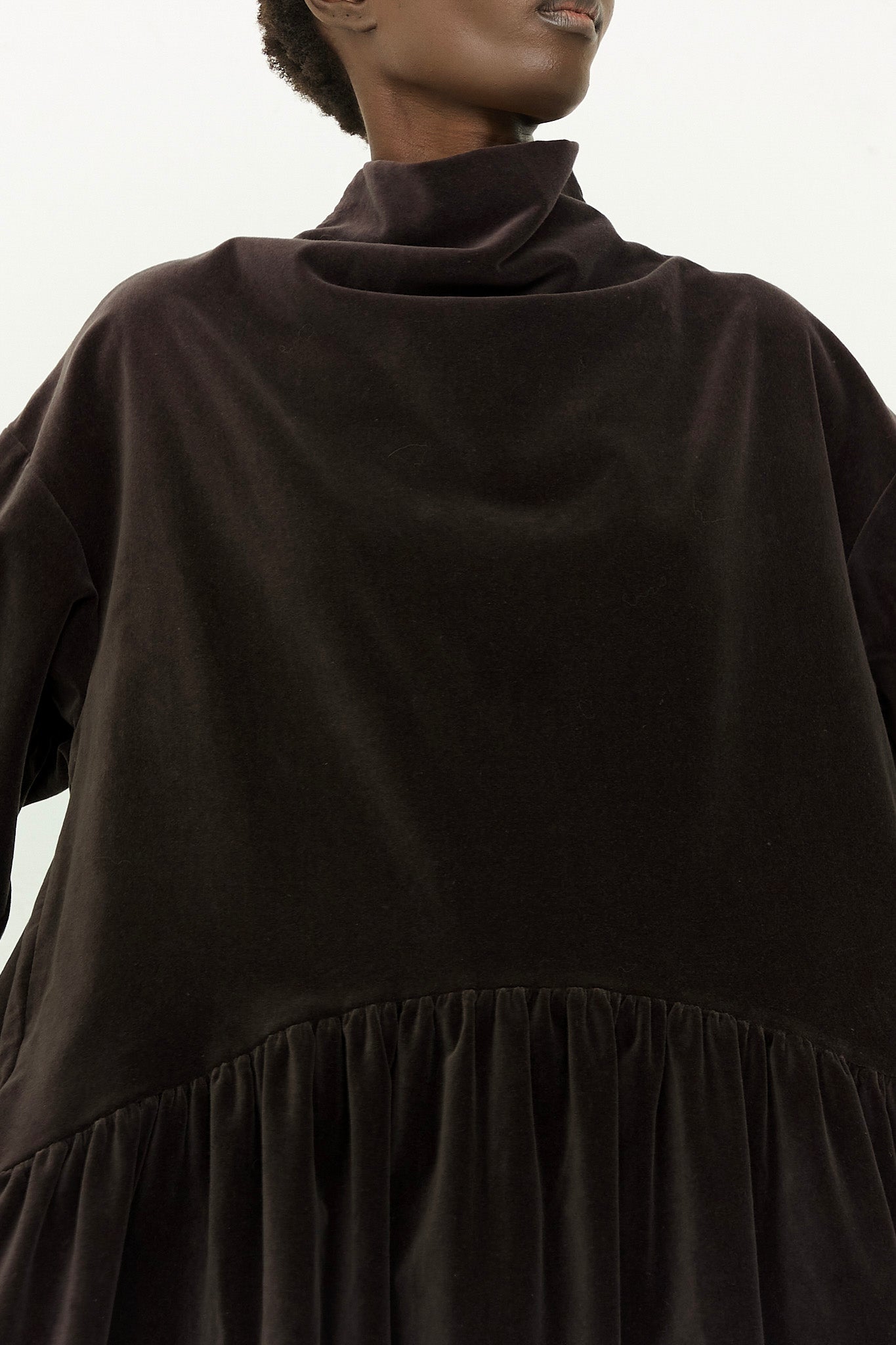 A black top with a ruffled hem.