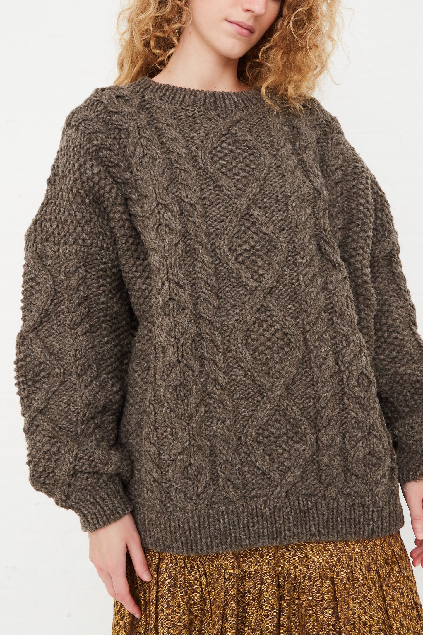 The model is wearing a Wool Hand-Knit Pullover in Mocha by Ichi Antiquités.