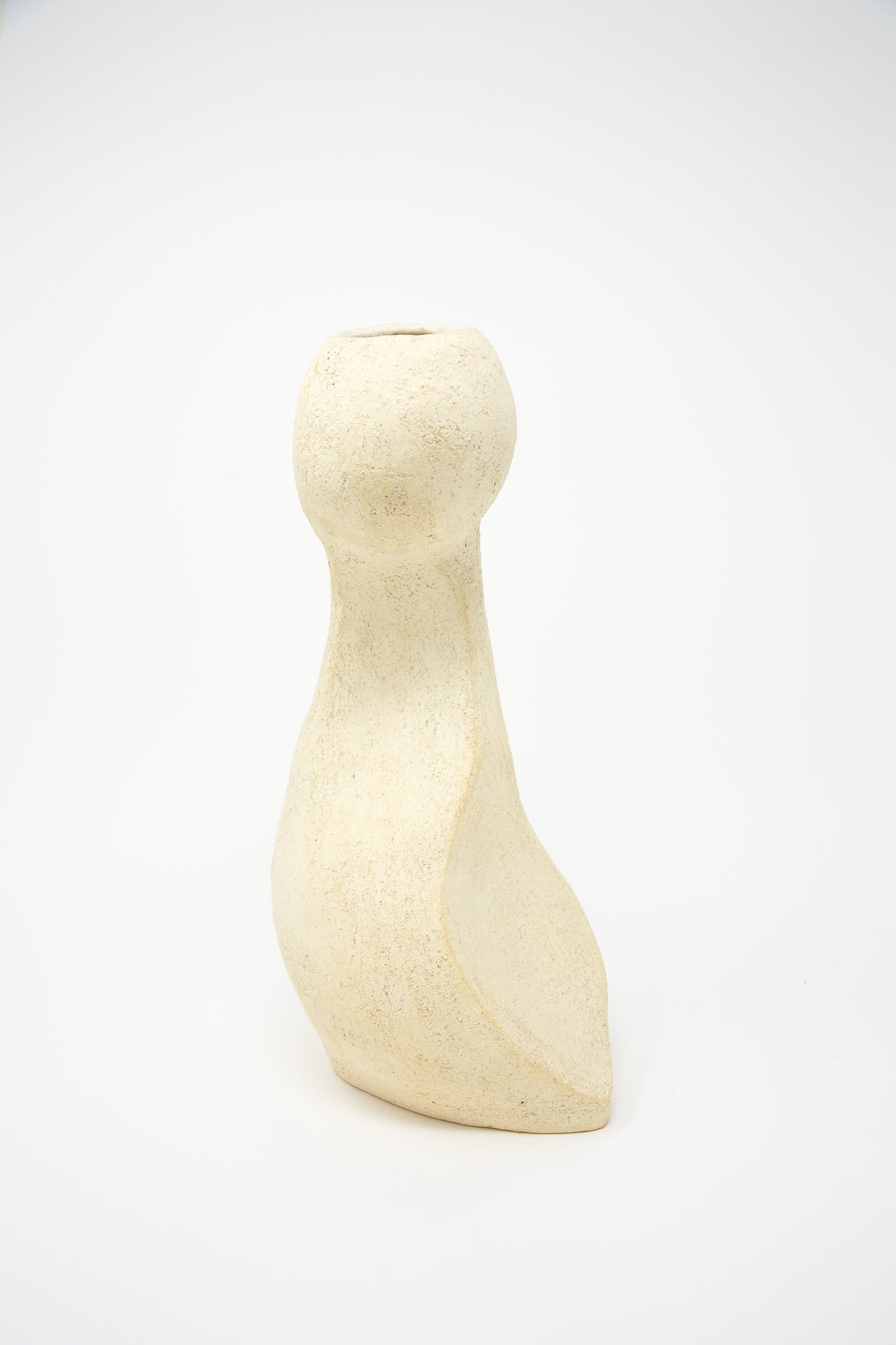 Description: A Lost Quarry medium hand-built vessel No. 000713 bud vase sitting on a white surface, perfect for floral arrangements.