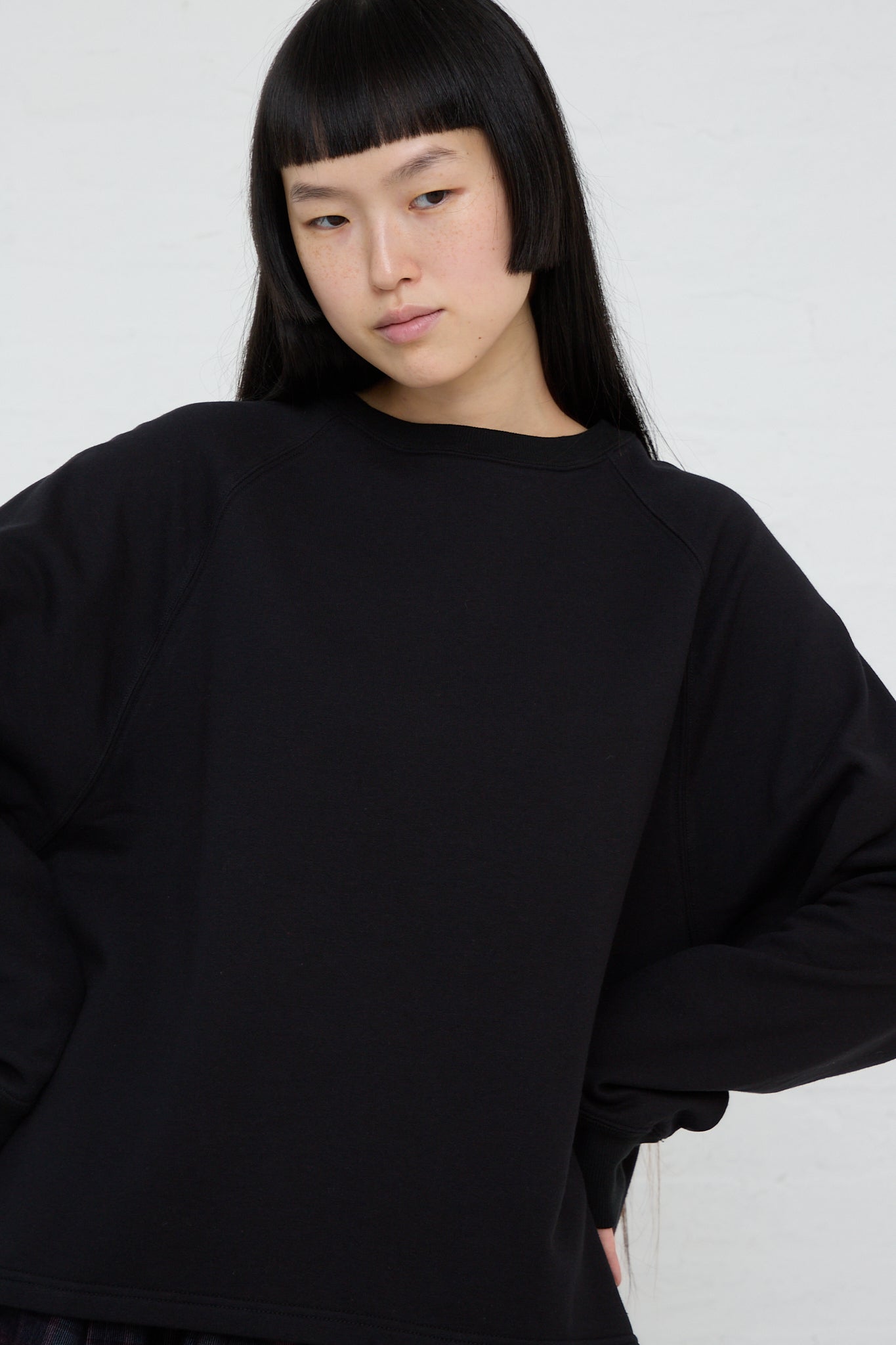 A model wearing an Ichi Cotton Knit Pullover in Black. Up close and front view.