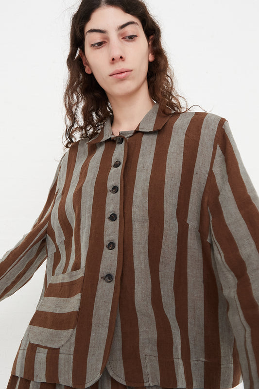 A model wearing a lightweight jacket in a striped linen. Features a fold-over collar and a 5-button placket. Front view and upclose highlight pocket details. Designed by Cawley - Oroboro Store
