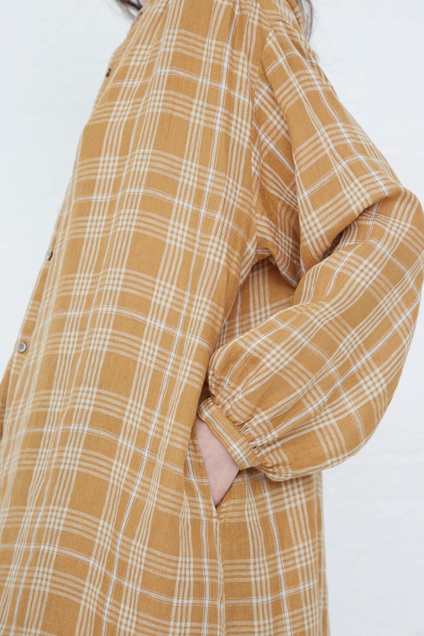 A woman wearing a relaxed fit, long sleeve Linen Check Dress in Camel shirt by Ichi Antiquités.