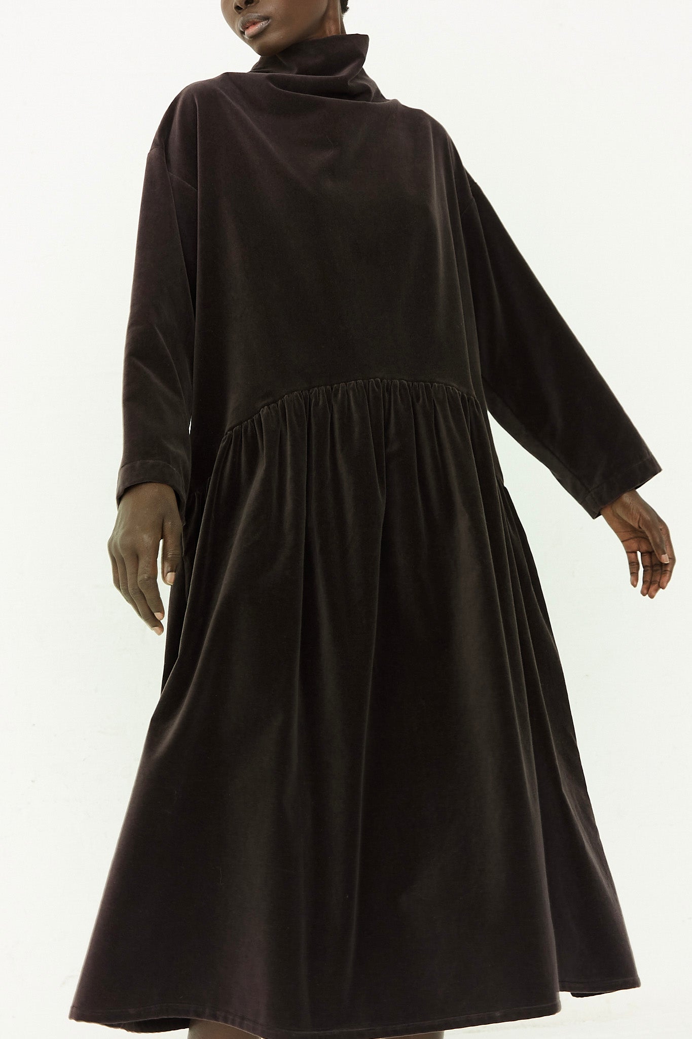 A woman wearing a black velvet dress.