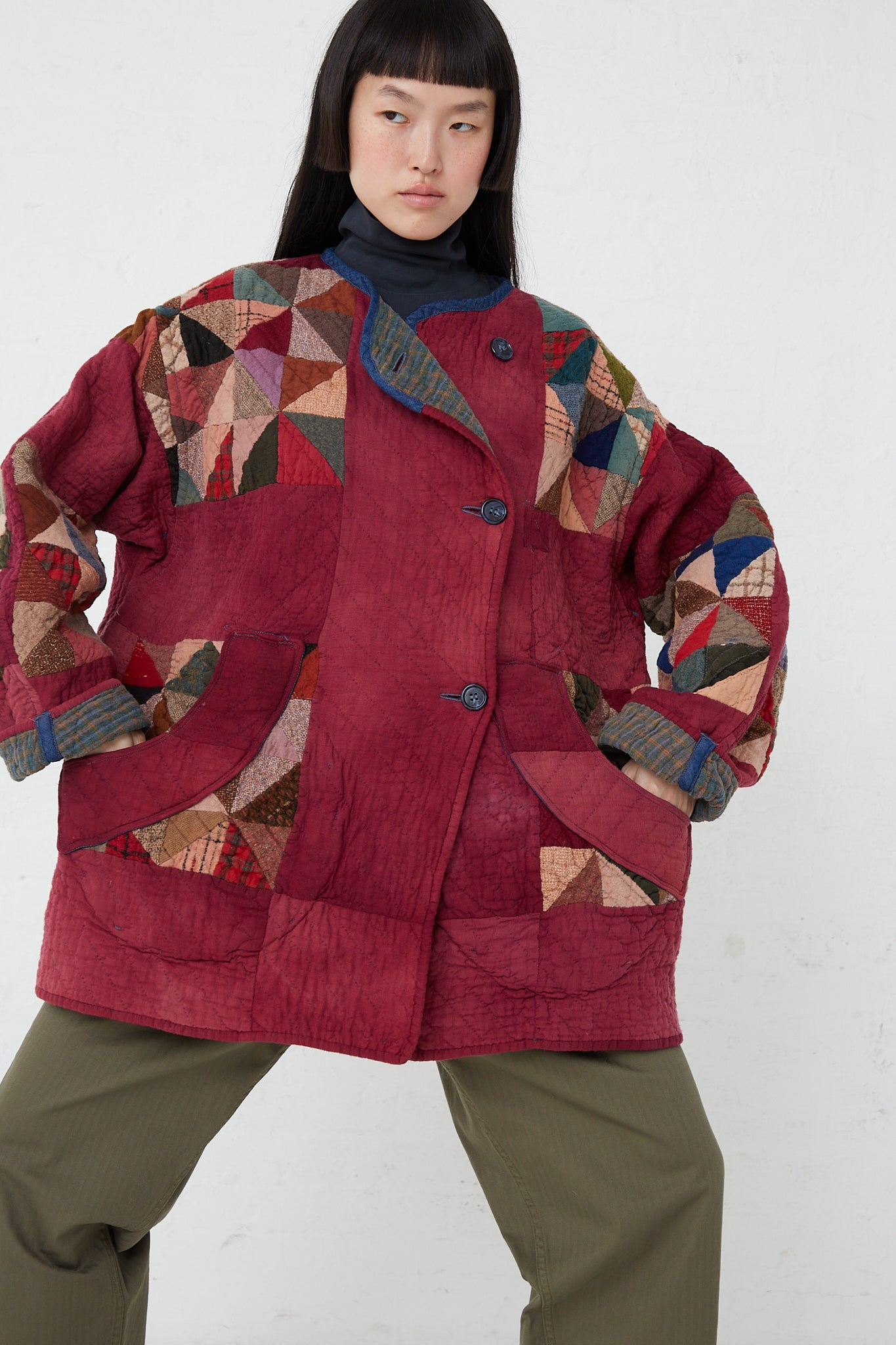 A woman wearing an oversized vintage As Ever Quilt Jacket in Mulberry.