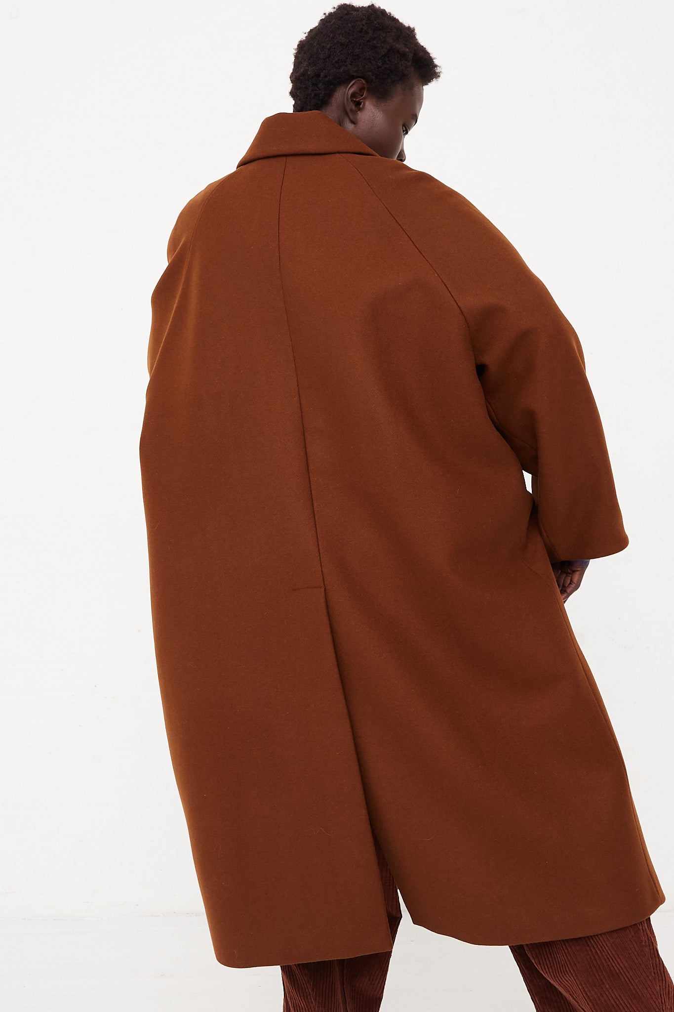 CORDERA Wool Coat Camel | Oroboro Store | Back image of coat upclose showing back of coat details on model