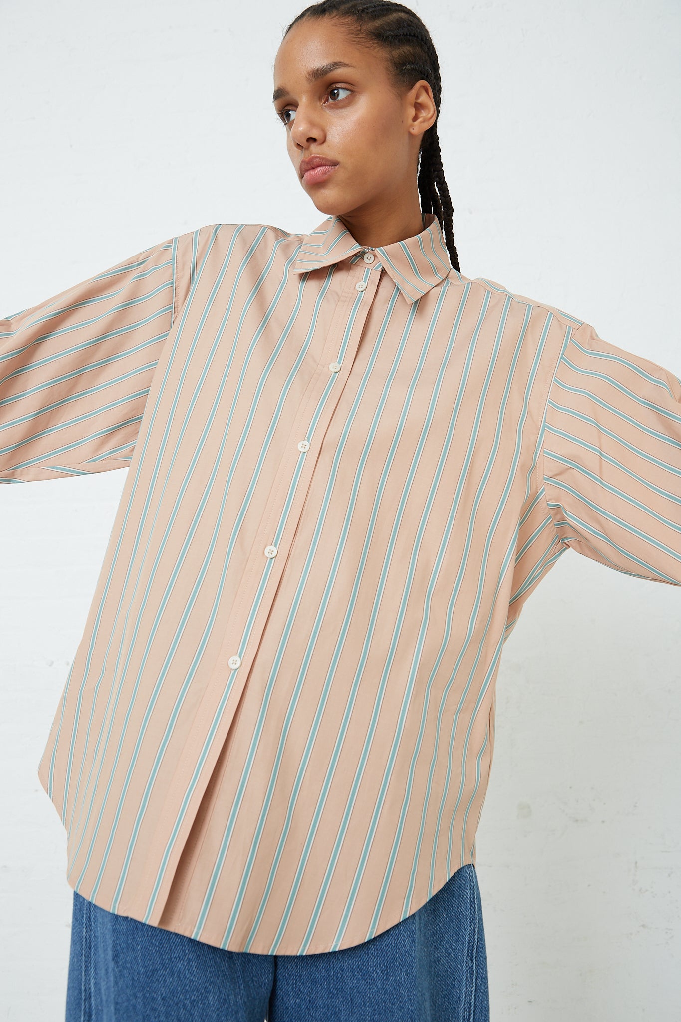 The model is wearing a Rachel Comey Stripe Broadcloth Risa Top in Terracotta.