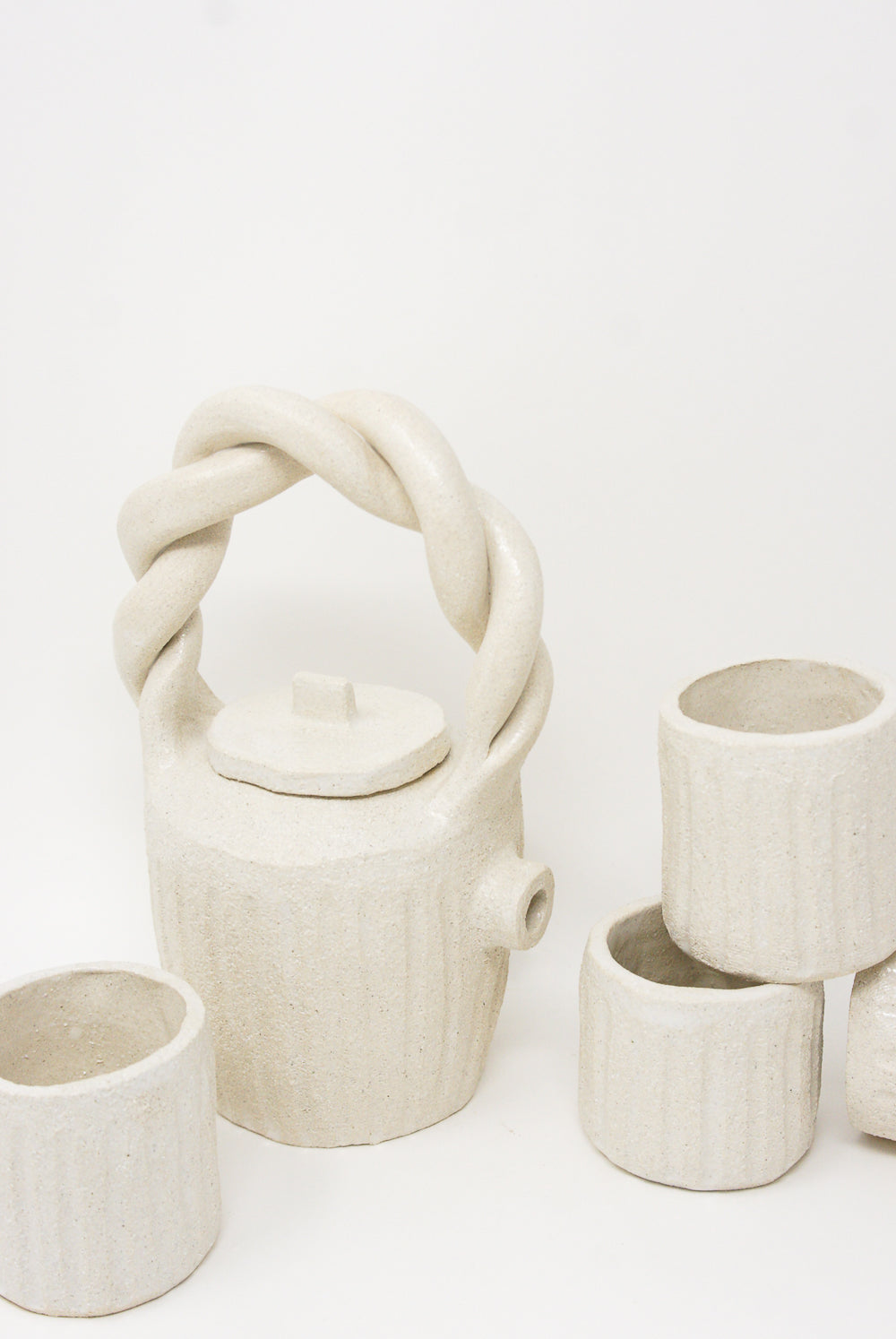 A Tea Cup in Natural by Clandestine on a white surface, handmade in Spain.