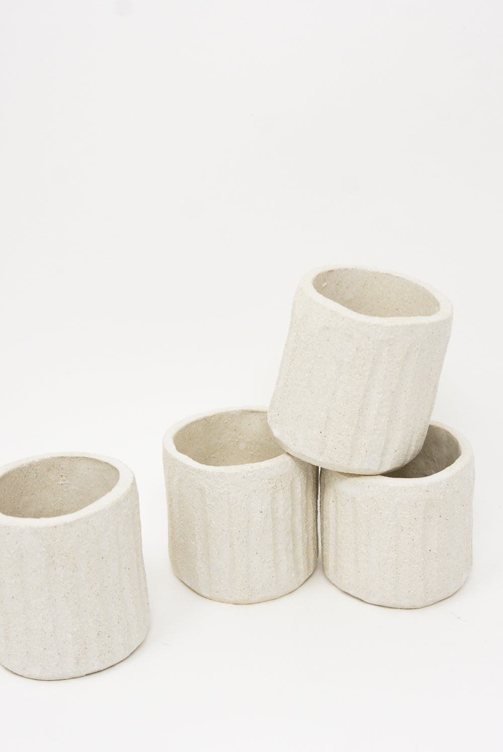 Four Tea Cups in Natural handmade in Spain on a white surface. (Brand: Clandestine)