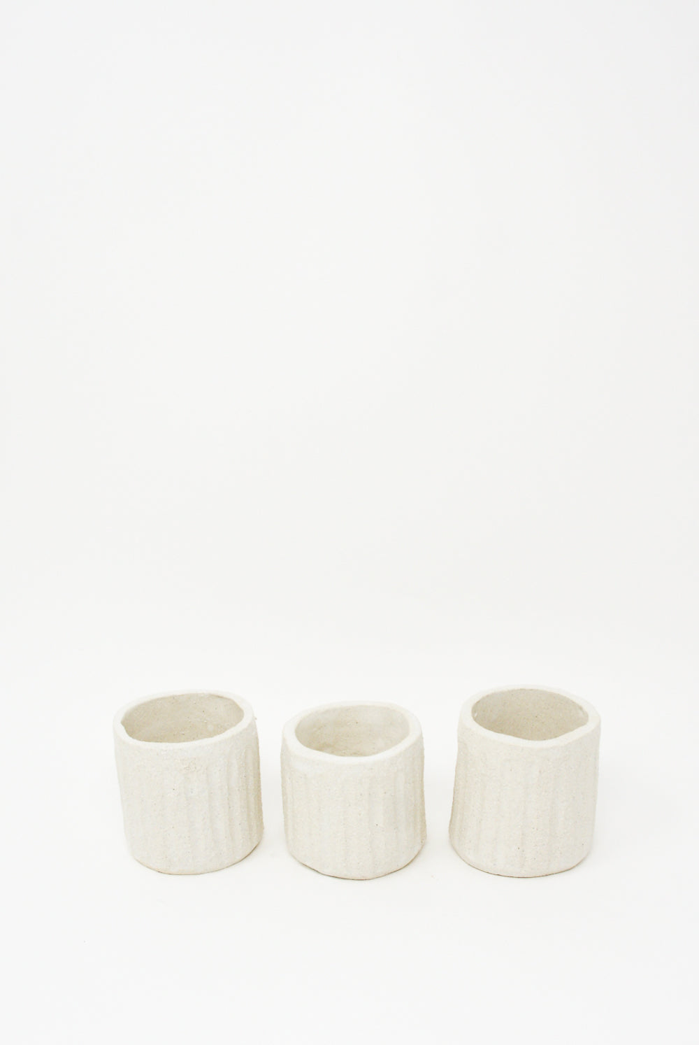 Three Clandestine Tea Cups in Natural on a white surface.