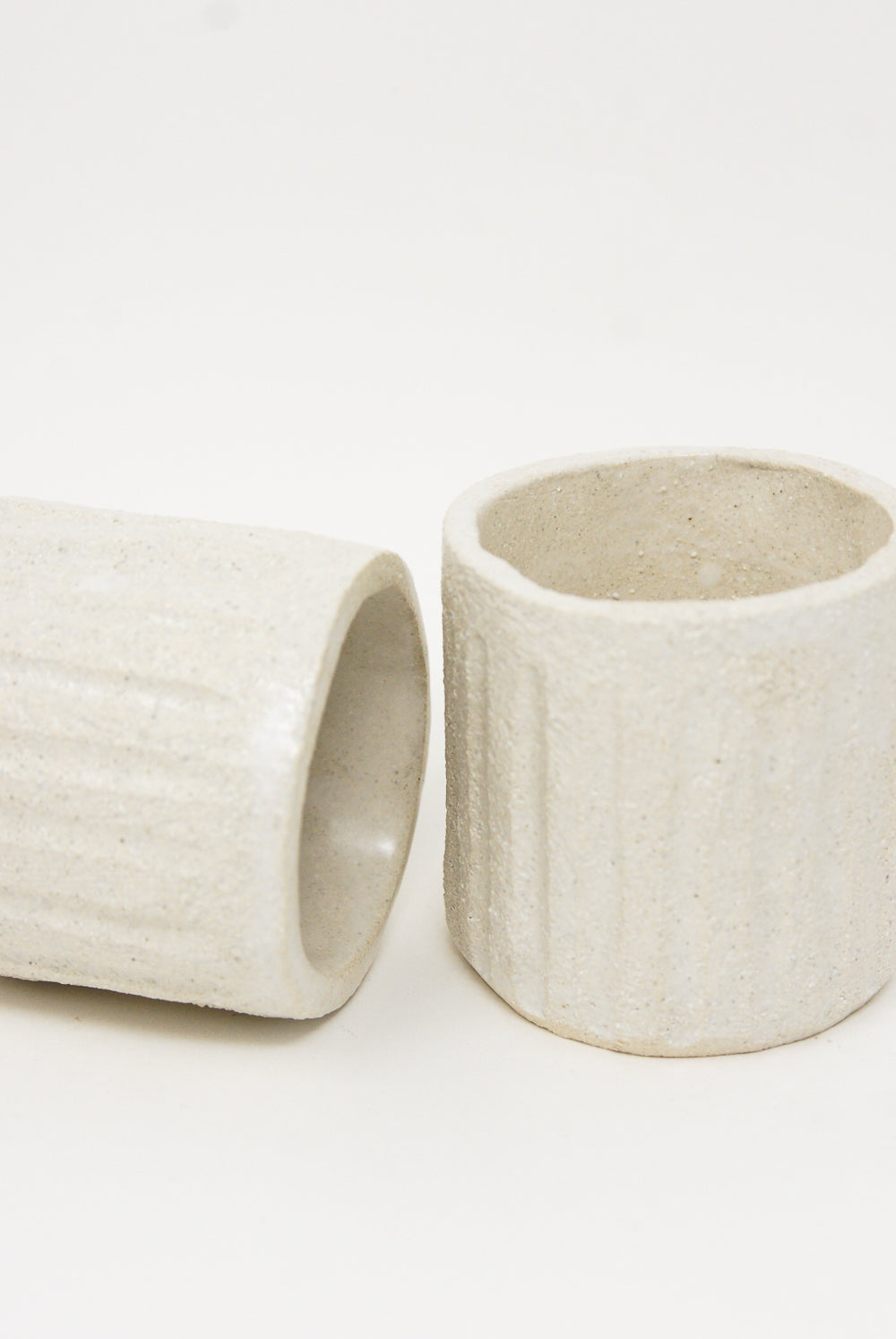 Two Clandestine tea cups in natural on a white surface.