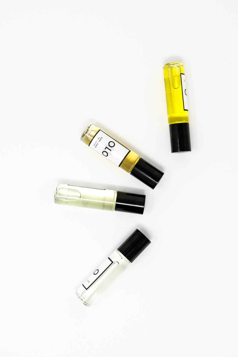 Four 9 ml bottles of Fragrance Palo Santo by OLO are arranged on a white surface.