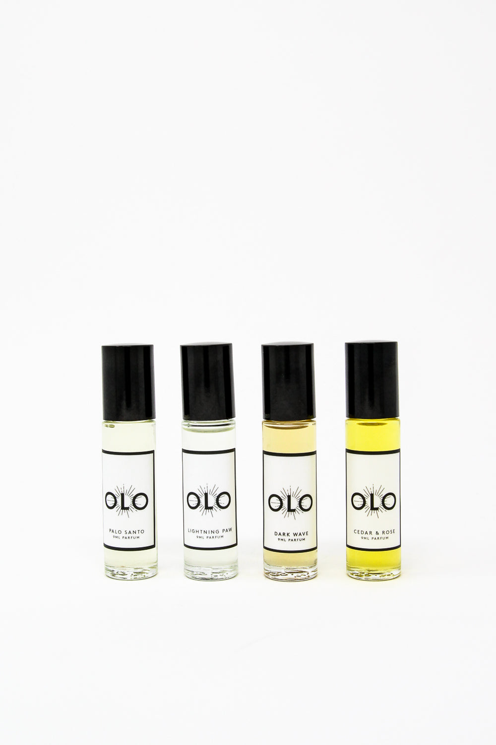Four OLO fragrance bottles, featuring scents such as Palo Santo, Lightning Paw, Dark Wave, and Cedar & Rose, displayed on a white background.