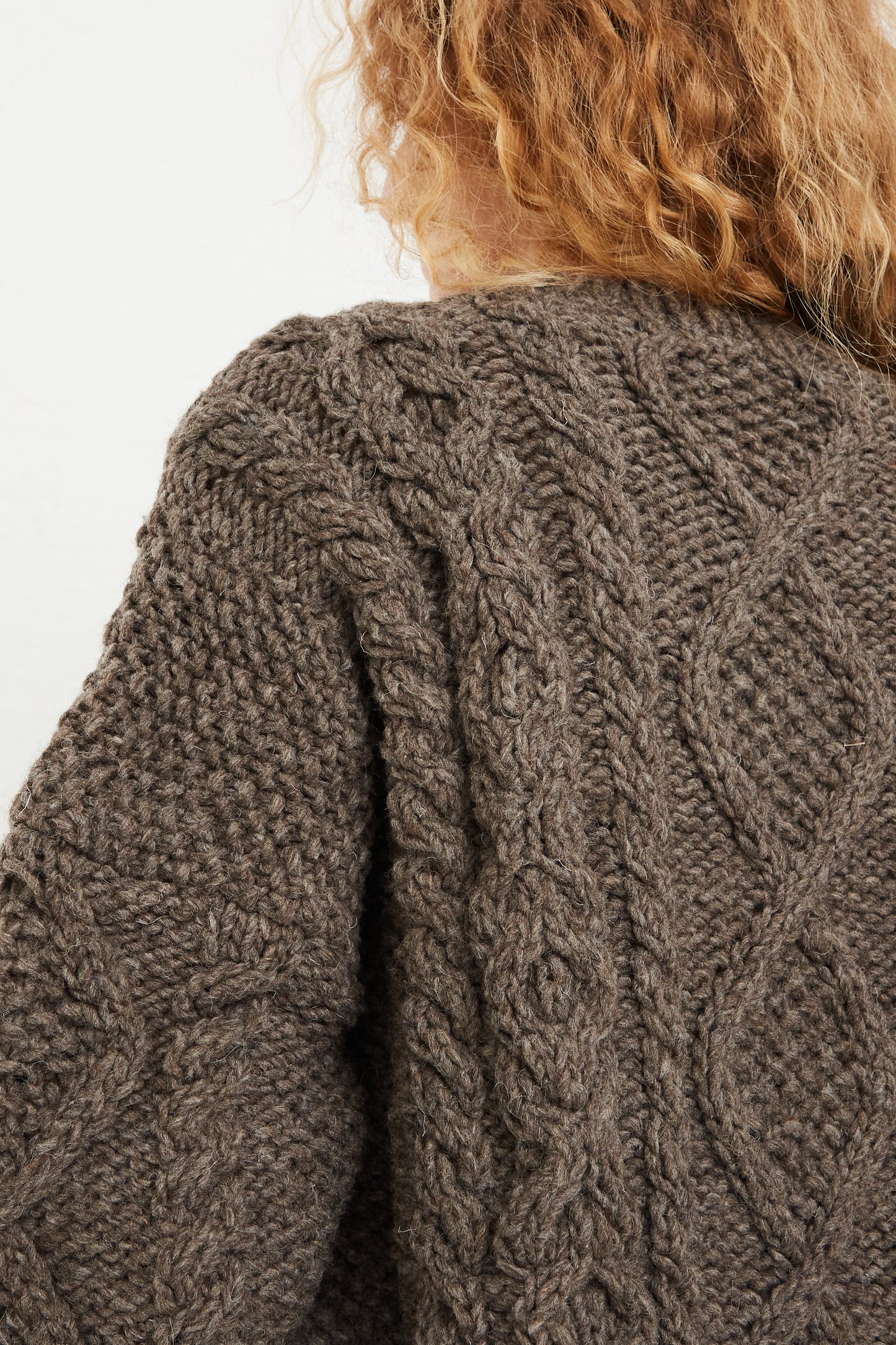 The back view of a model wearing an Ichi Antiquités Wool Hand-Knit Pullover in Mocha.