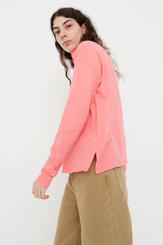 A model wearing B Sides' Cotton Turtleneck Shirt in Calla Pink.