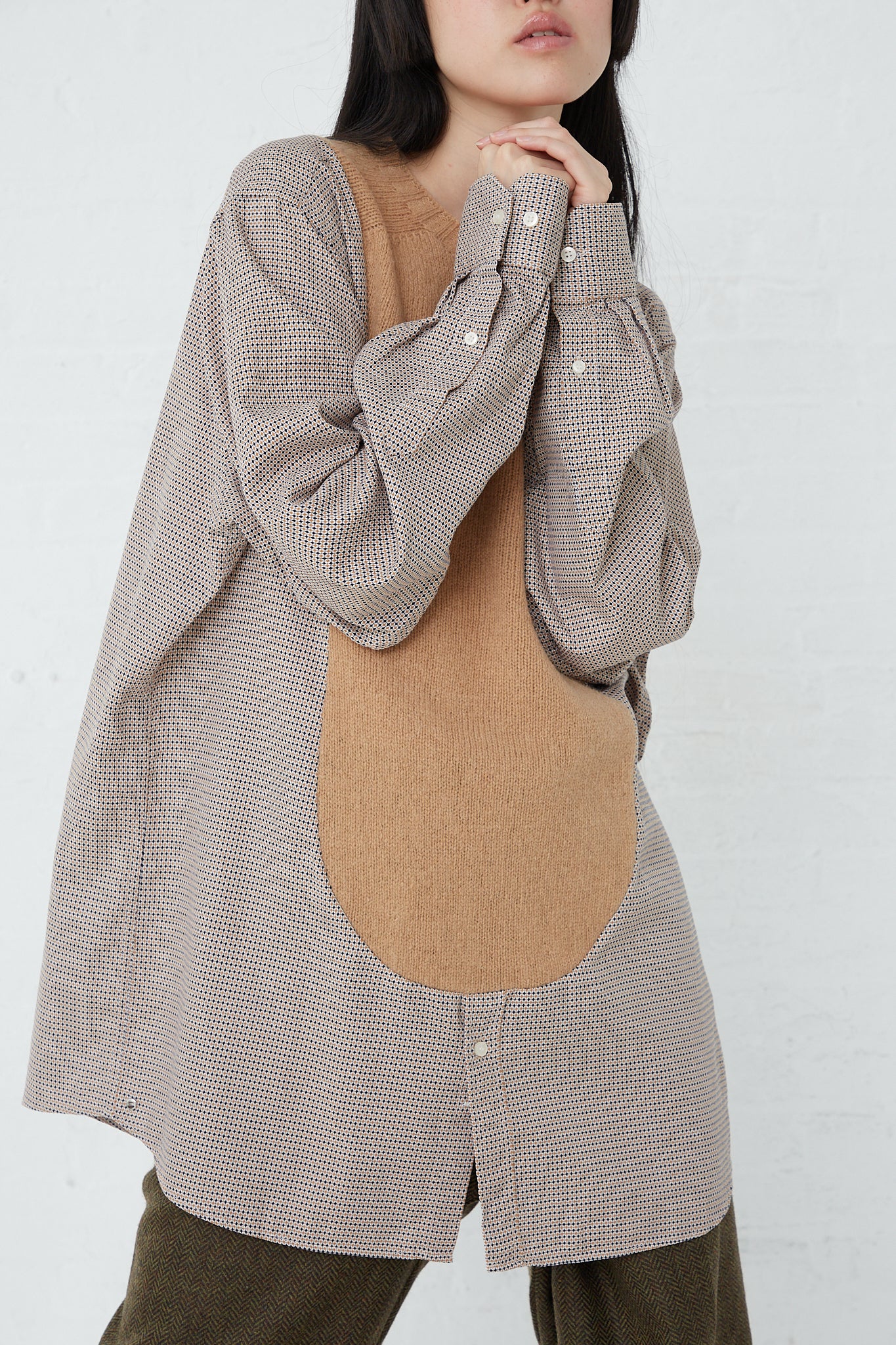 A woman wearing a long sleeve No. 68 Front Insert Pullover in Beige Pattern made of Shetland wool by Bless.