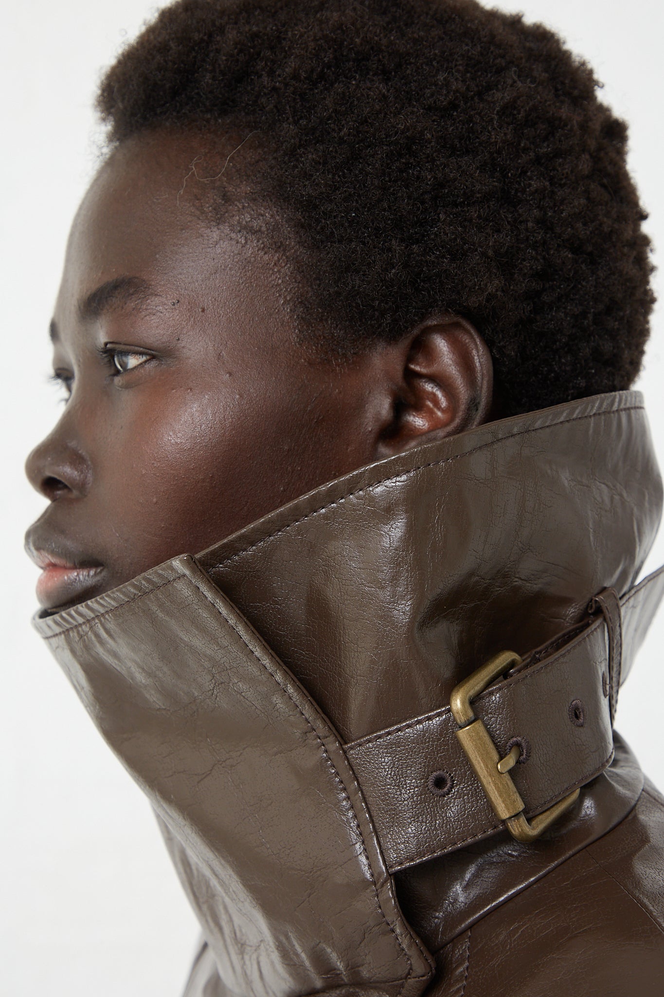 A woman wearing a Rejina Pyo Faux Leather Juno Jacket in Dark Brown.
